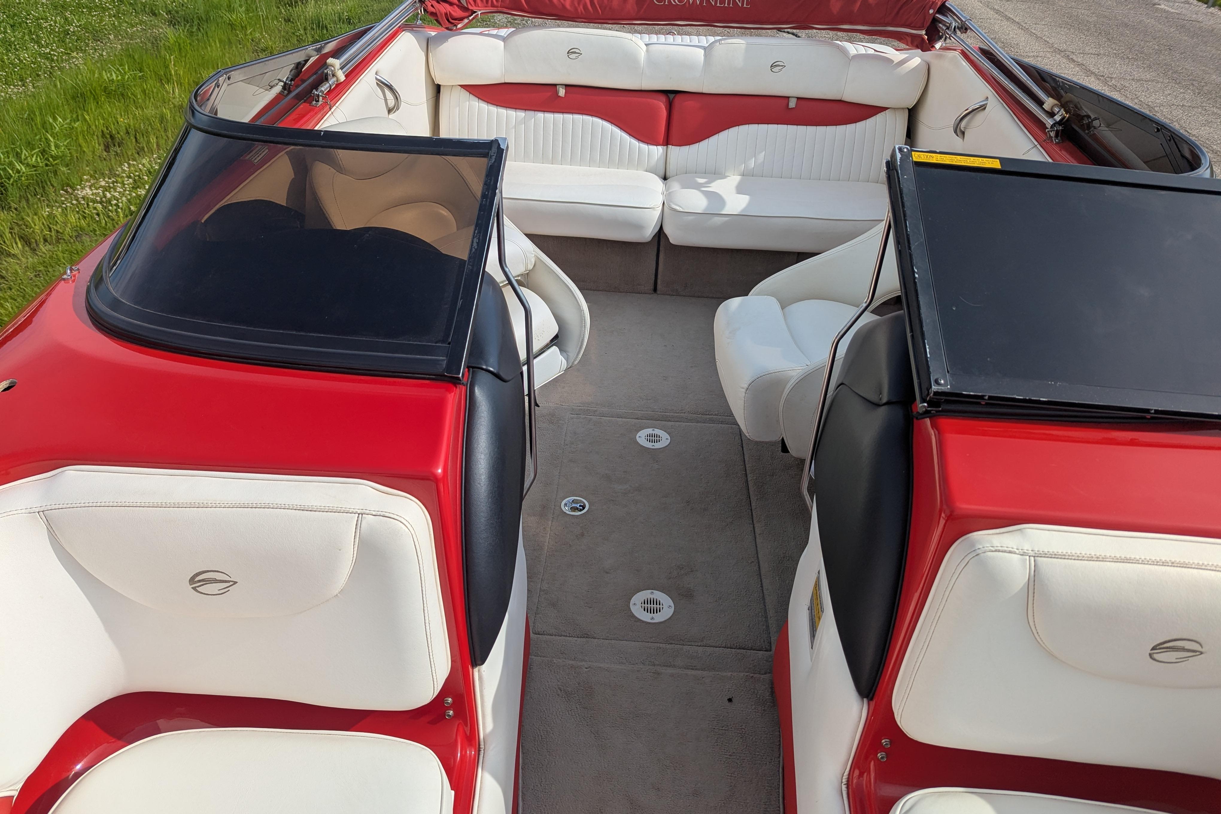 2004 Crownline 225 BR boat interior with red and white seating, open layout.