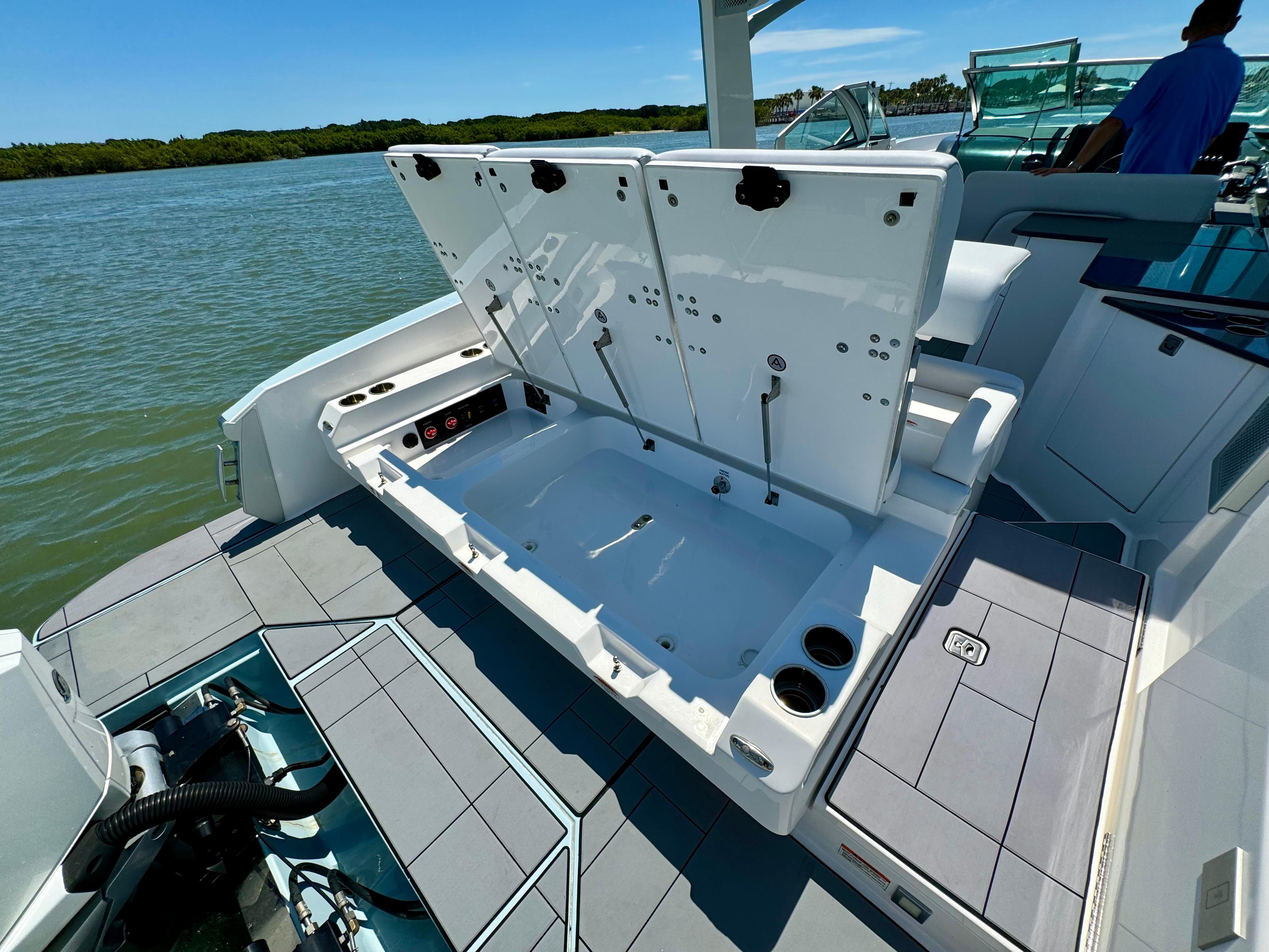 Aviara-AV32 OB 2021 -FL-US-2021 Aviara AV32 OB boat with open storage compartment on a sunny day.-9443715 | Thumbnail
