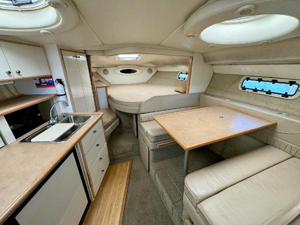 1997 Maxum 3200 SCR cabin interior with kitchenette, dining area, and sleeping quarters.