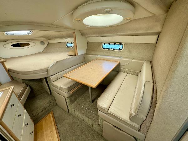 1997 Maxum 3200 SCR cabin interior with dining area and sleeping quarters.