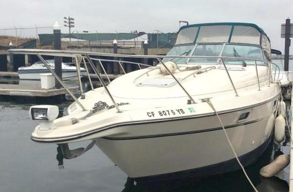 1997 Maxum 3200 SCR boat docked at marina, front view.
