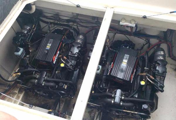 Twin engines in a 1997 Maxum 3200 SCR boat, showcasing detailed mechanical components.