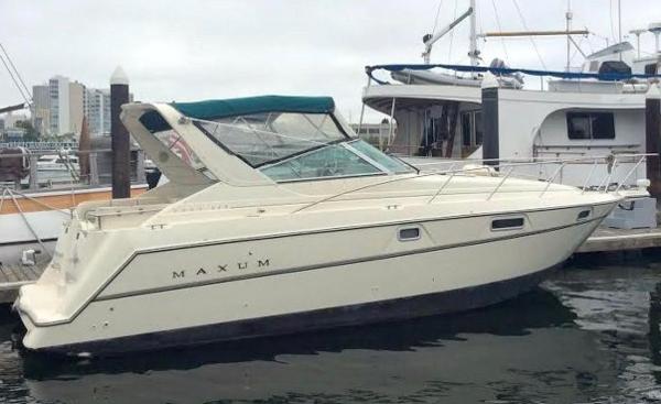 1997 Maxum 3200 SCR boat docked at marina, side view.