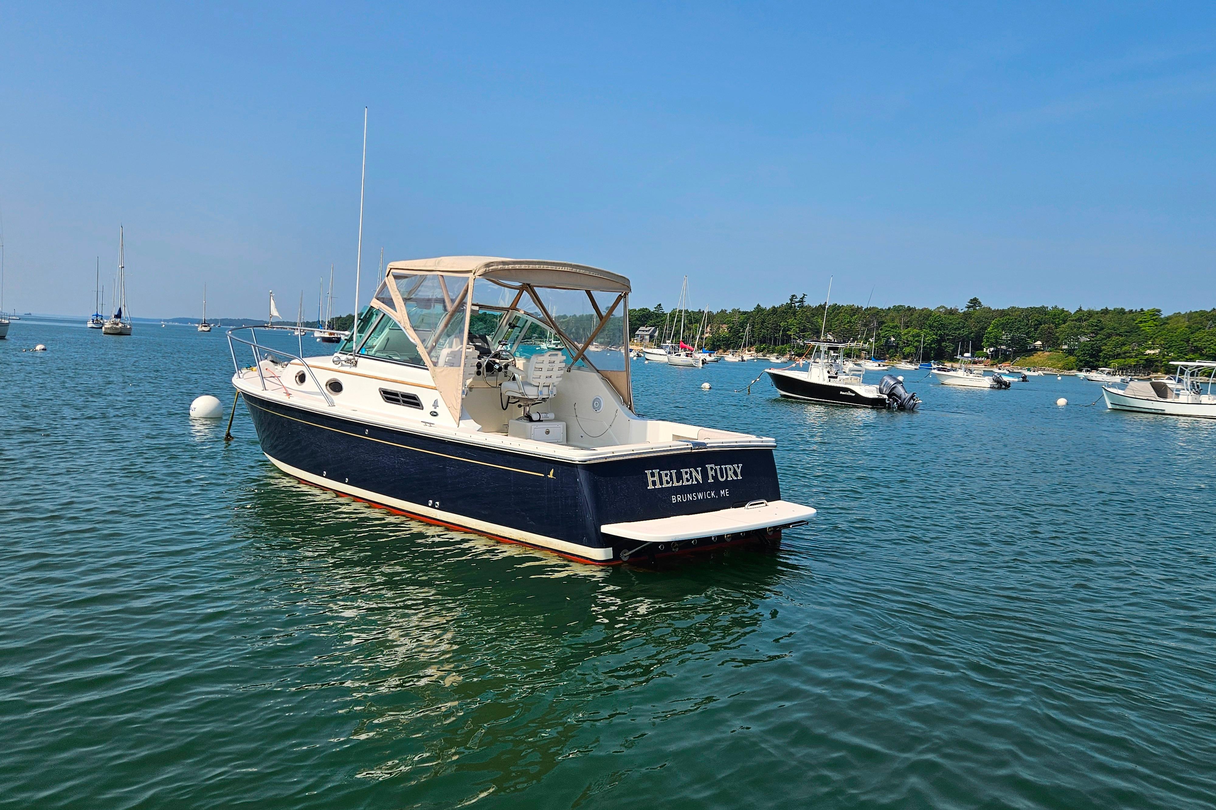 2006 Back Cove 26 boat named u0022Helen Furyu0022 moored in a scenic harbor.