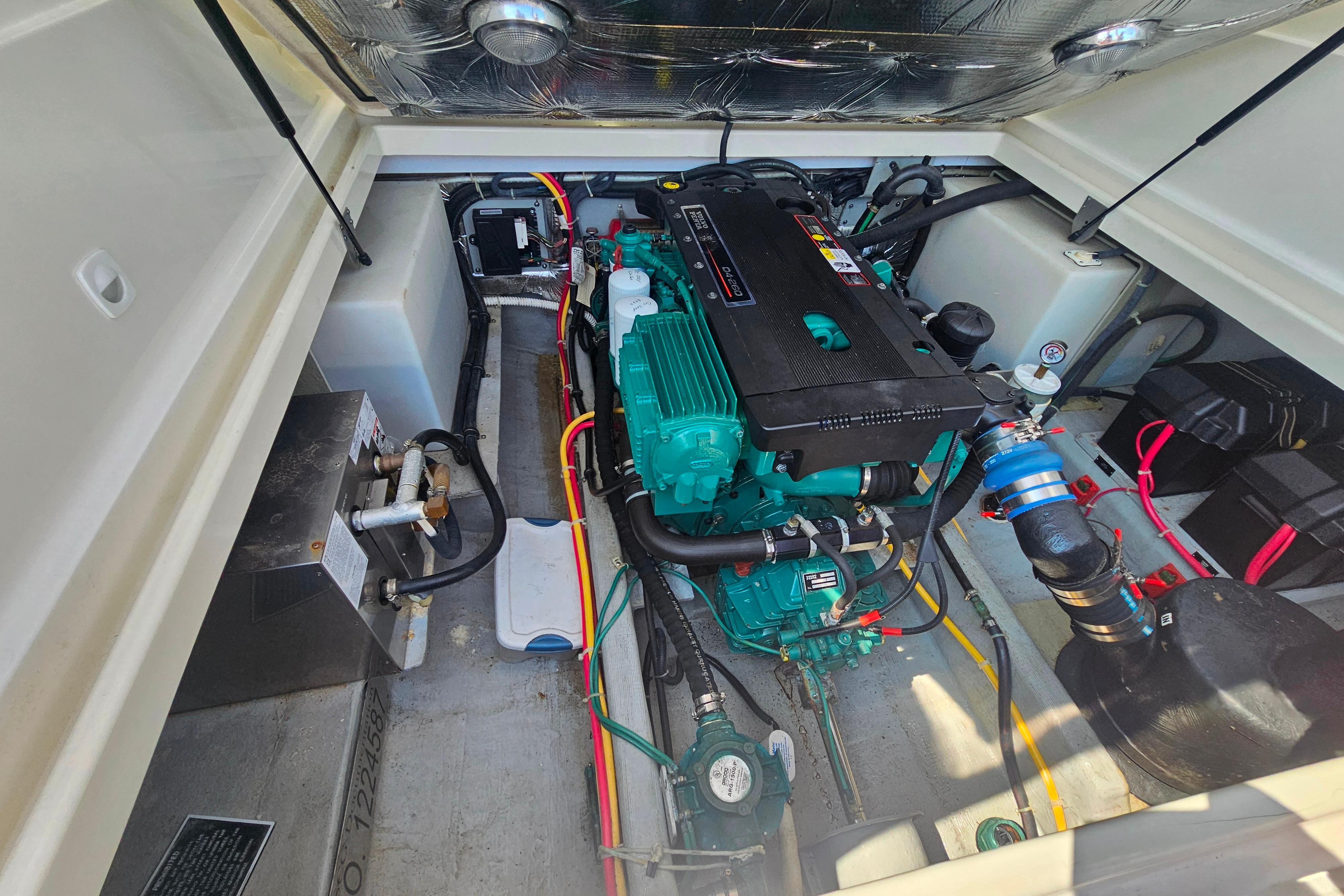 Engine compartment of a 2006 Back Cove 26 boat, showcasing detailed mechanical components.