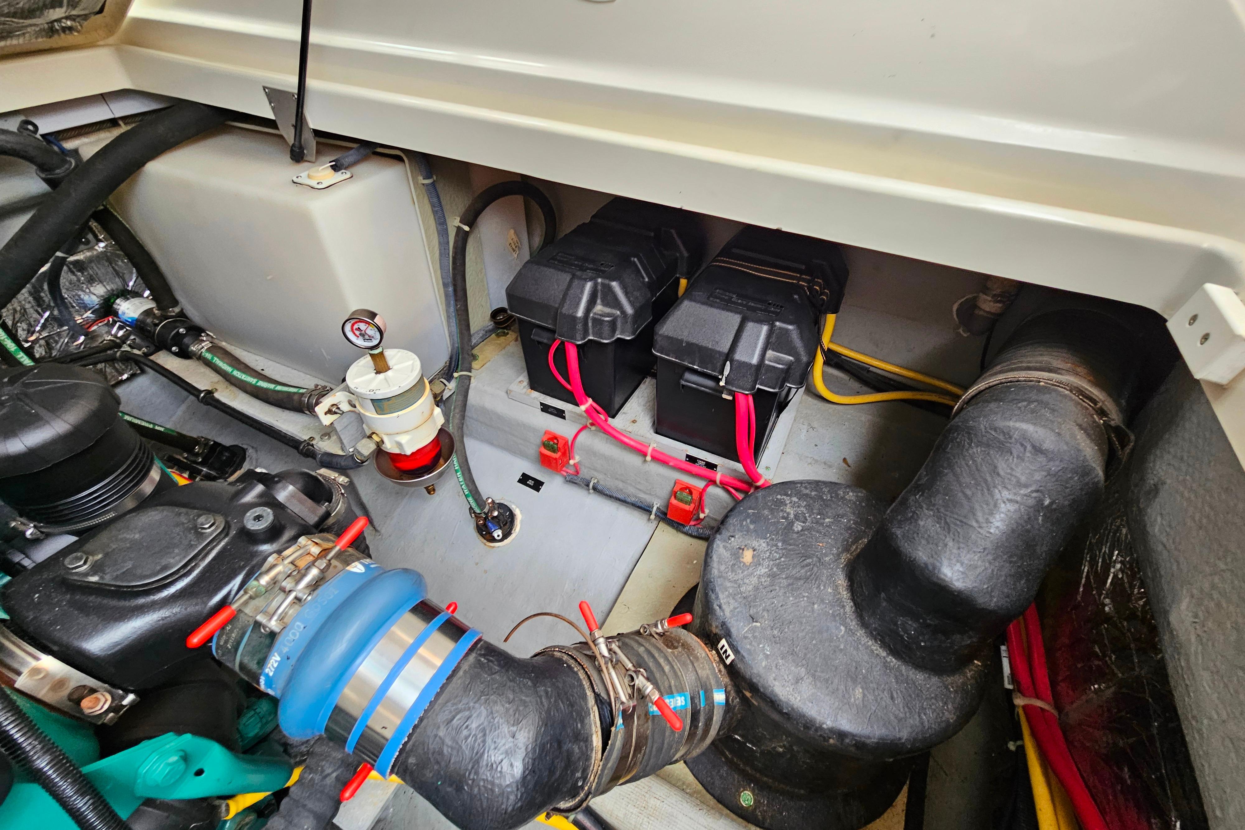 Engine compartment of a 2006 Back Cove 26 boat, showing batteries and wiring.