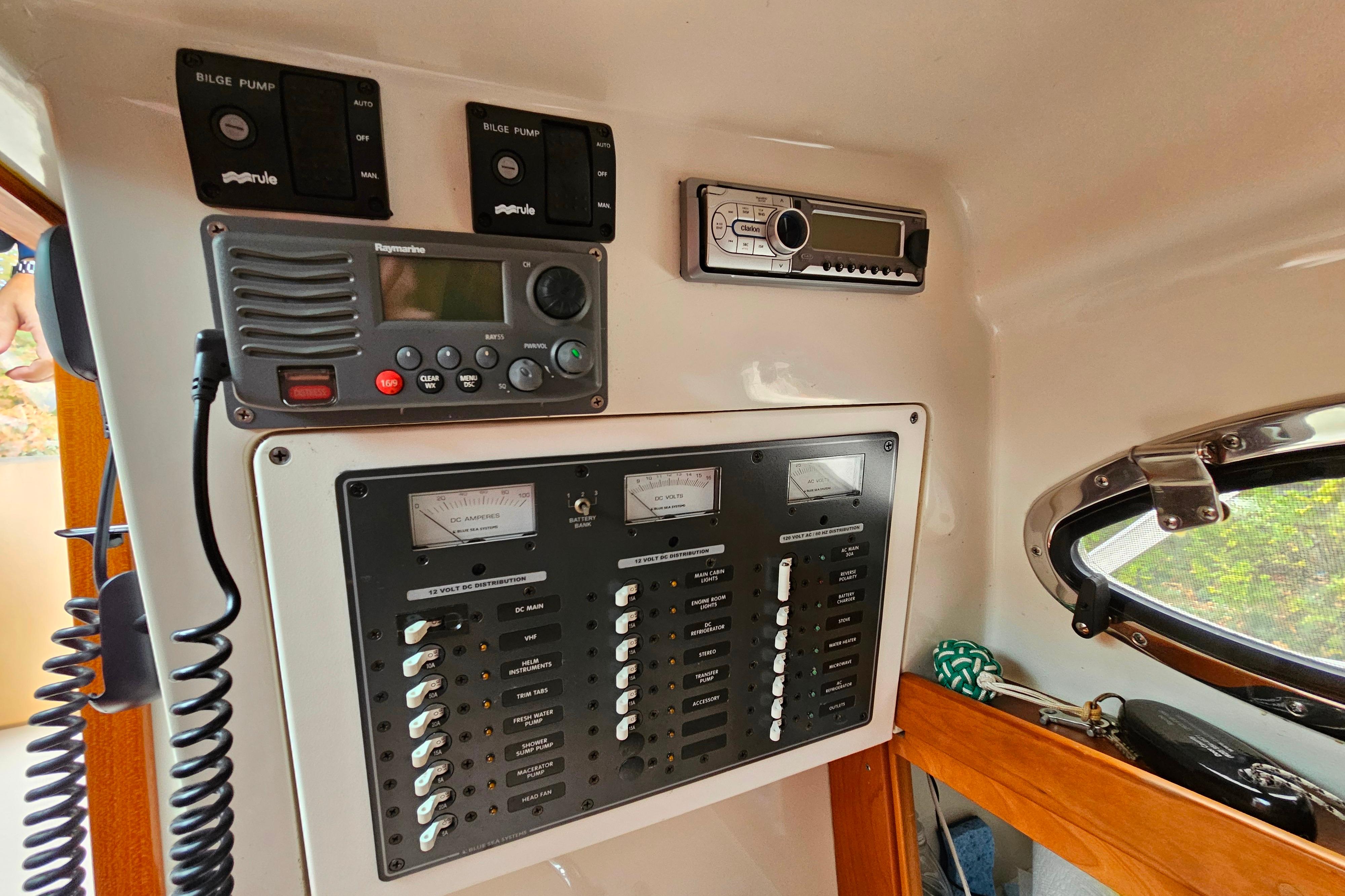 Control panel of a 2006 Back Cove 26 boat with radio and switches.