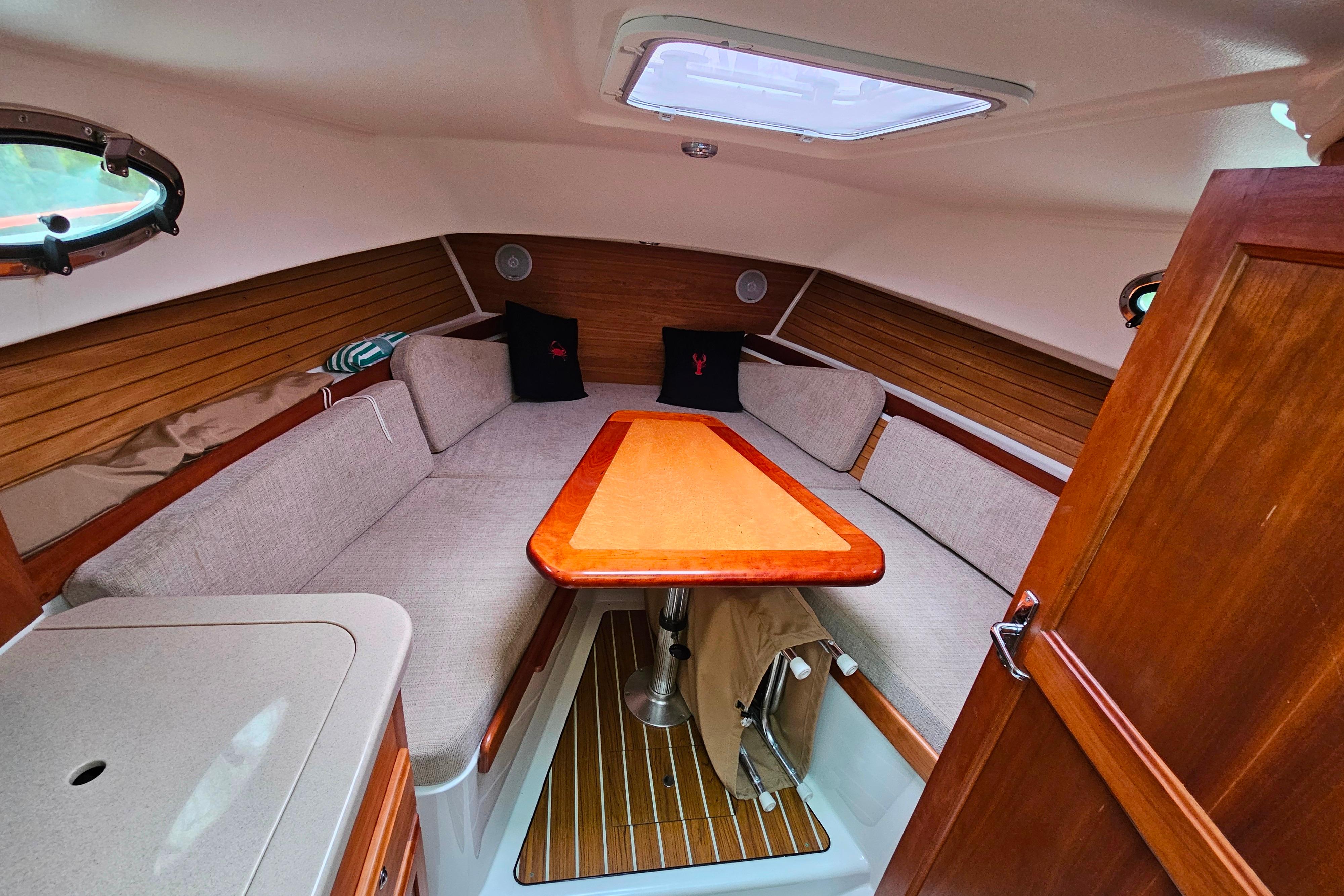 2006 Back Cove 26 cabin interior with wood accents and cozy seating area.