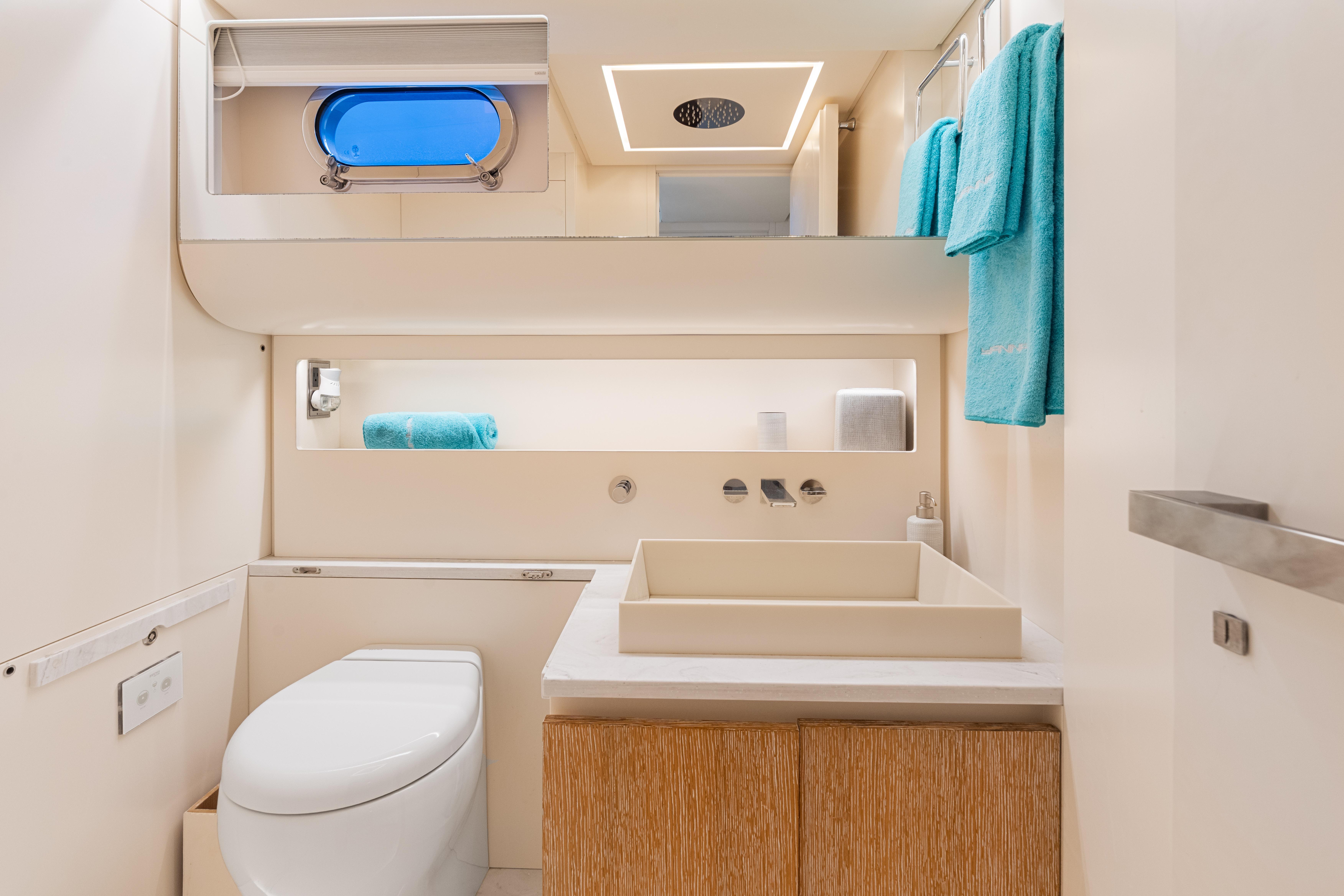 CNM-Continental 54 2019-YANINA FL-US-Luxurious yacht bathroom with modern fixtures, blue towels, and sleek design on CNM Continental 54T.-9803754 | Thumbnail