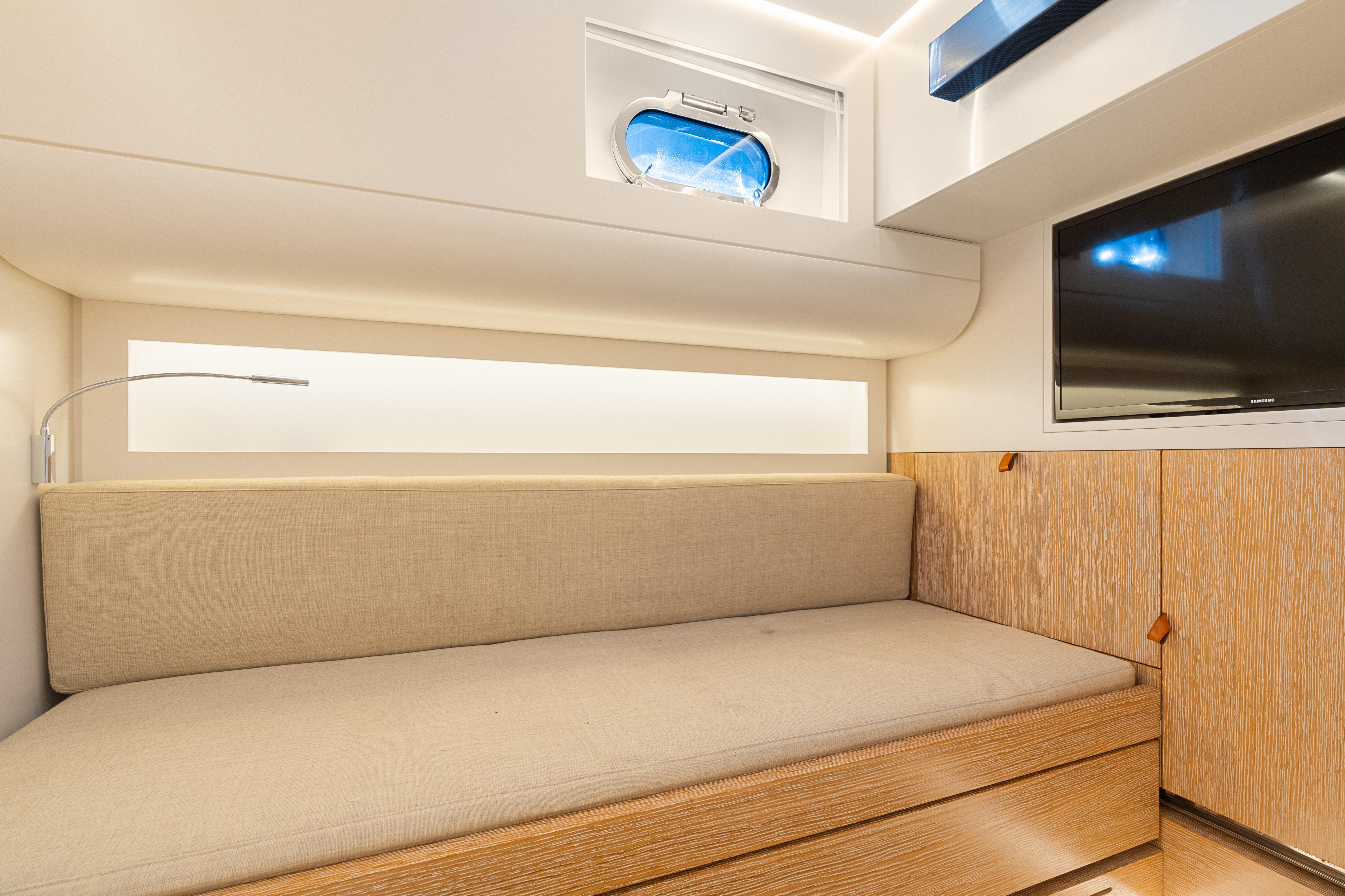 CNM-Continental 54 2019-YANINA FL-US-Modern interior of 2019 CNM Continental 54T yacht with sofa, TV, and porthole window.-9803754 | Thumbnail