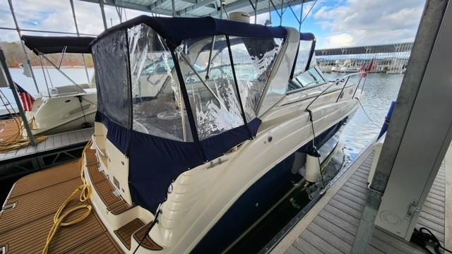 2005 Rinker Fiesta Vee 342 boat docked under a covered marina.