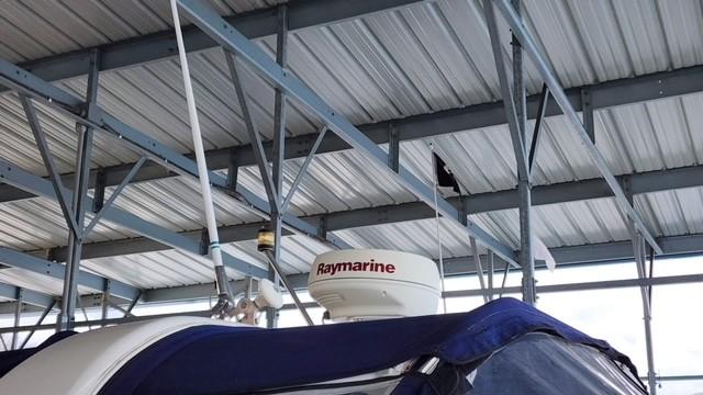 2005 Rinker Fiesta Vee 342 with Raymarine radar under metal roof.