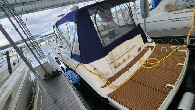 2005 Rinker Fiesta Vee 342 docked under a covered marina.