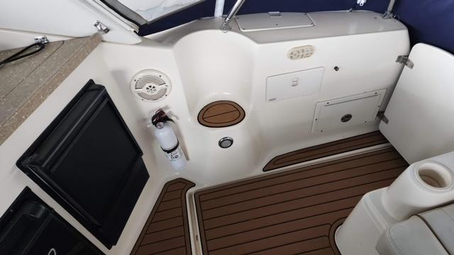 2005 Rinker Fiesta Vee 342 boat interior with wood flooring and storage compartments.