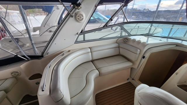 2005 Rinker Fiesta Vee 342 boat interior with beige seating and wood flooring.