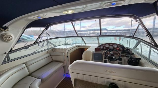 2005 Rinker Fiesta Vee 342 boat interior with steering console and seating area.