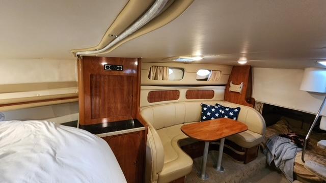 2005 Rinker Fiesta Vee 342 cabin interior with seating and wooden table.