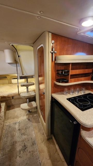 2005 Rinker Fiesta Vee 342 cabin interior with kitchenette and sleeping area.
