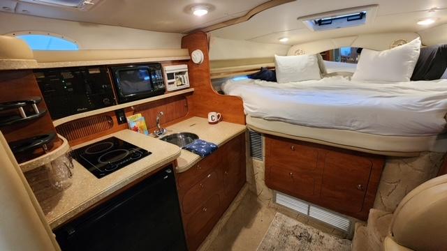 2005 Rinker Fiesta Vee 342 interior with kitchen and cozy sleeping area.