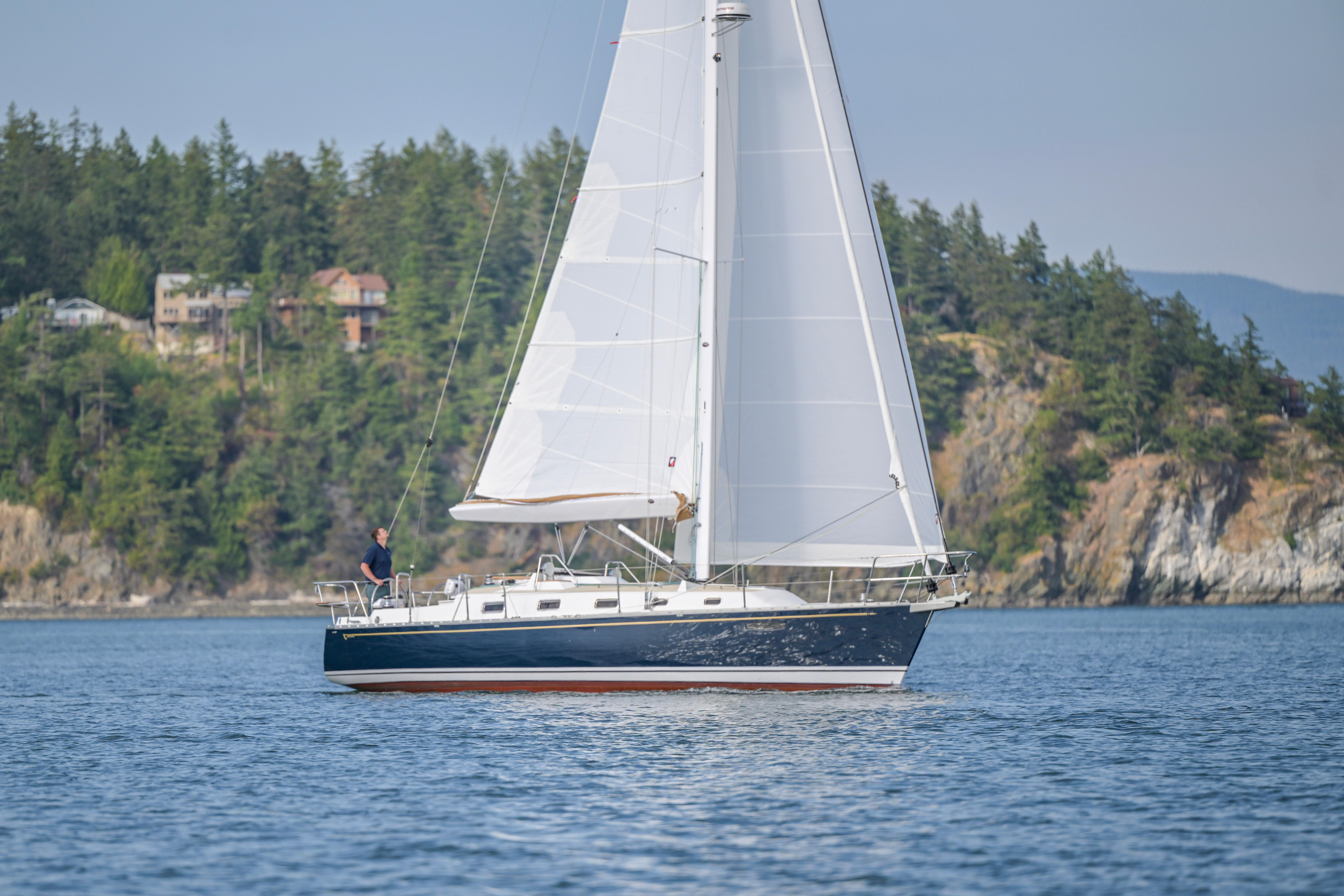 Tartan-365 2023-SEA #5 IN STOCK WA-US-2023 Tartan 365 sailboat cruising near forested coastline.-9568831 | Thumbnail