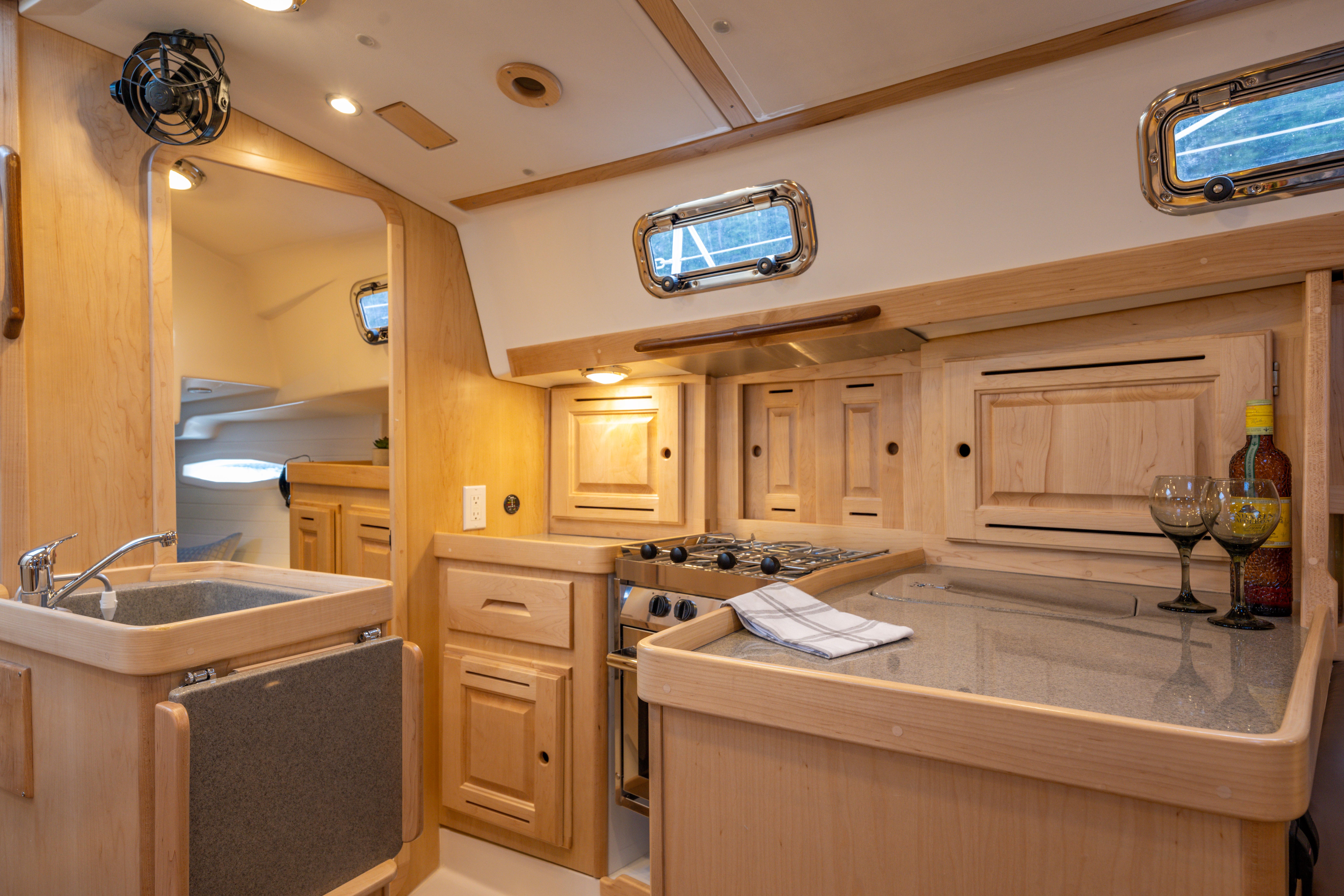 Tartan-365 2023-SEA #5 IN STOCK WA-US-Modern Tartan 365 yacht interior with wooden cabinetry, compact kitchen, and elegant lighting, 2023 model.-9568831 | Thumbnail