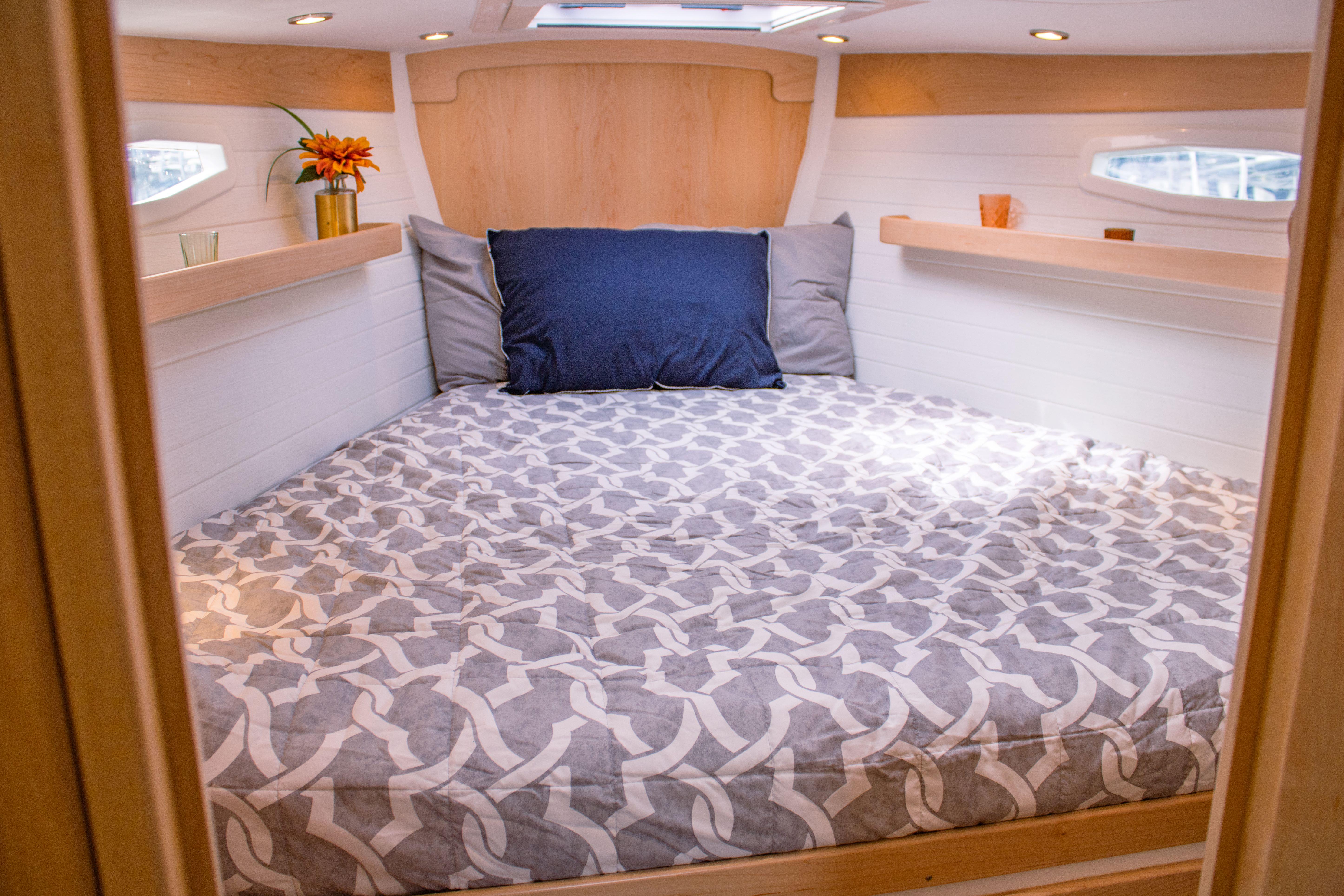 Tartan-365 2023-SEA #5 IN STOCK WA-US-Cozy cabin interior of 2023 Tartan 365 yacht with patterned bedding and decorative accents.-9568831 | Thumbnail