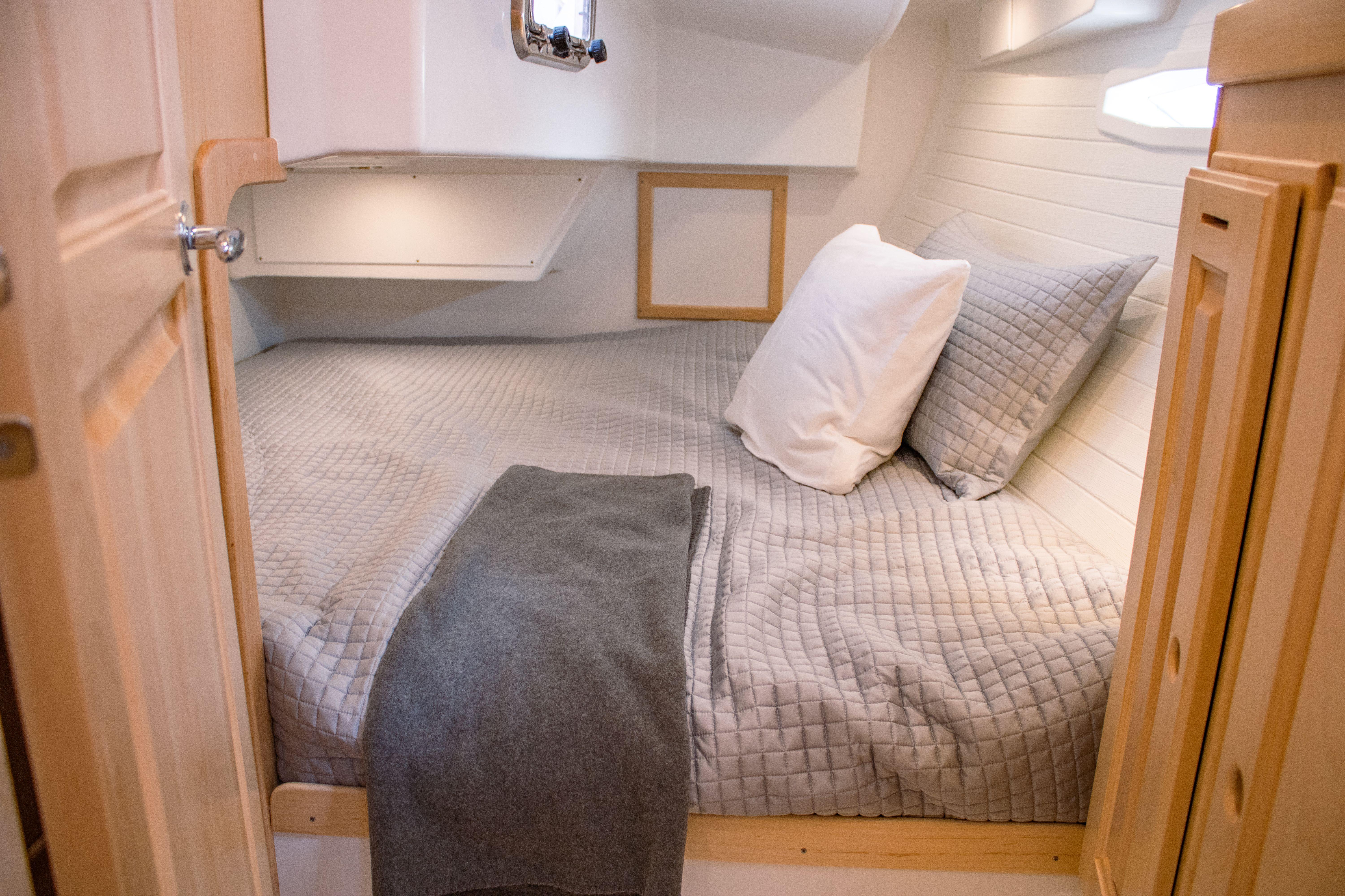 Tartan-365 2023-SEA #5 IN STOCK WA-US-Cozy cabin bedroom in 2023 Tartan 365 sailboat with gray bedding and wooden accents.-9568831 | Thumbnail