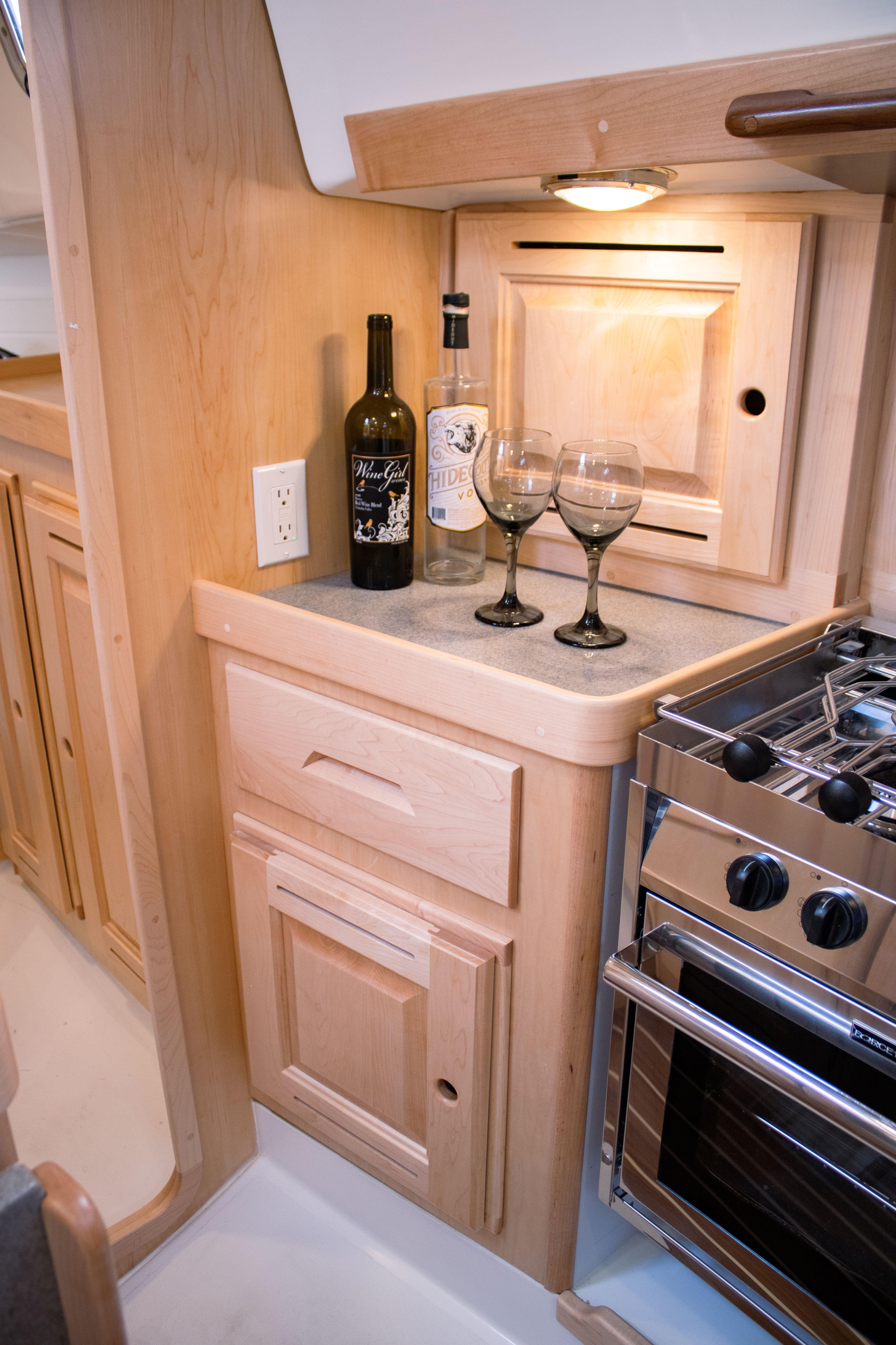 Tartan-365 2023-SEA #5 IN STOCK WA-US-2023 Tartan 365 yacht kitchen with wine, glasses, and stove.-9568831 | Thumbnail