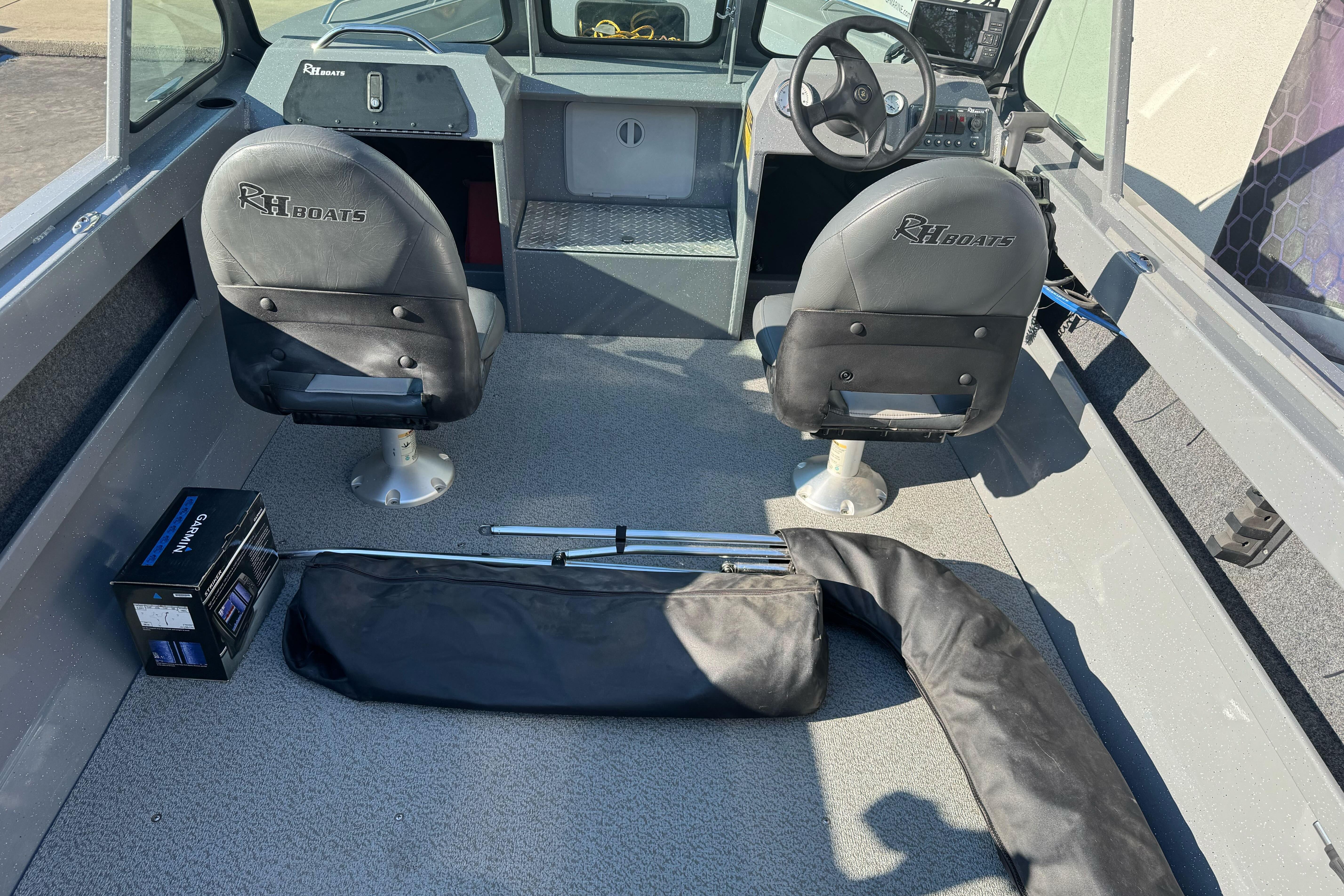 2017 RH Boats 18 SH interior with two seats, steering wheel, and equipment.