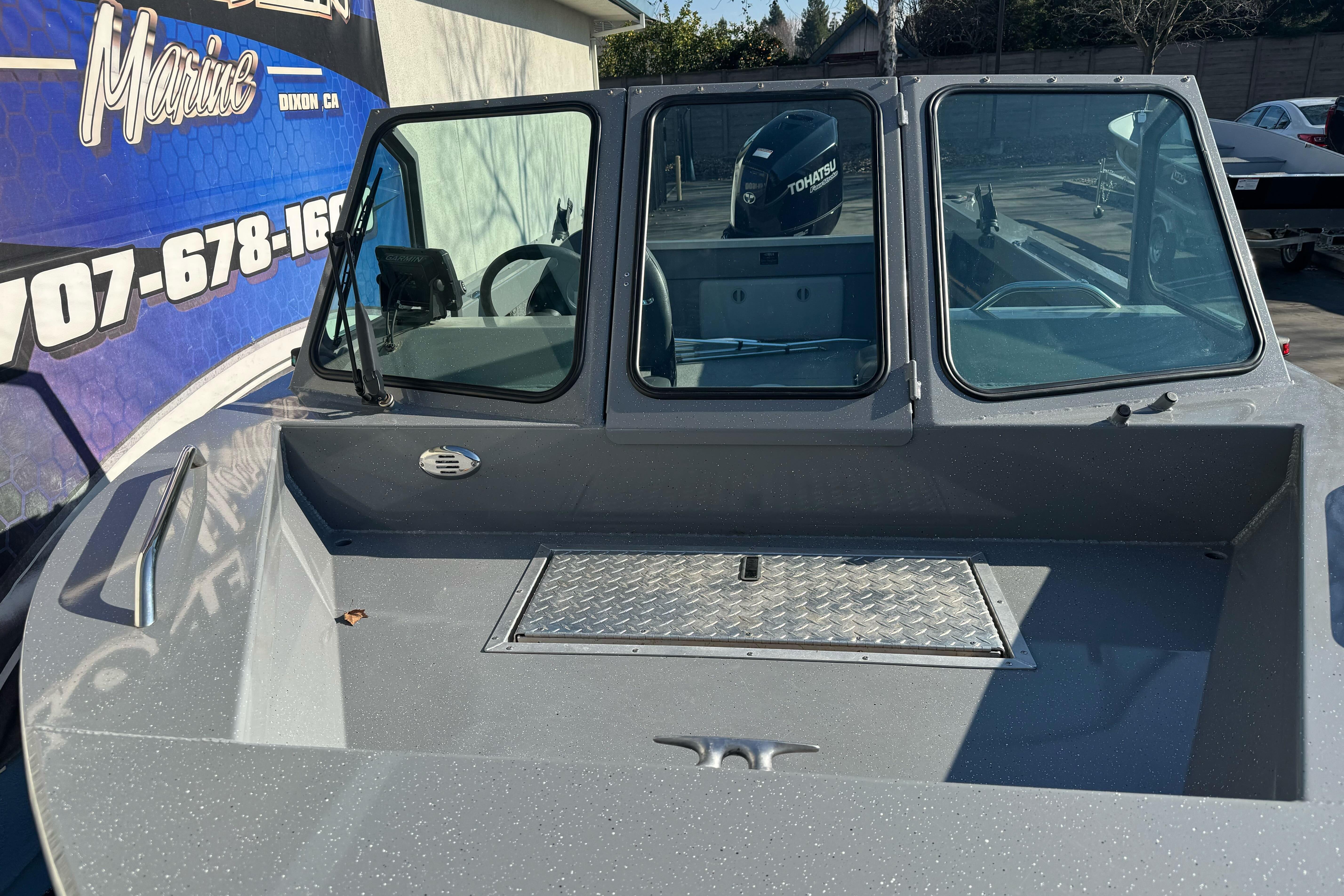 2017 RH Boats 18 SH with windshield and Tohatsu motor, parked outdoors.