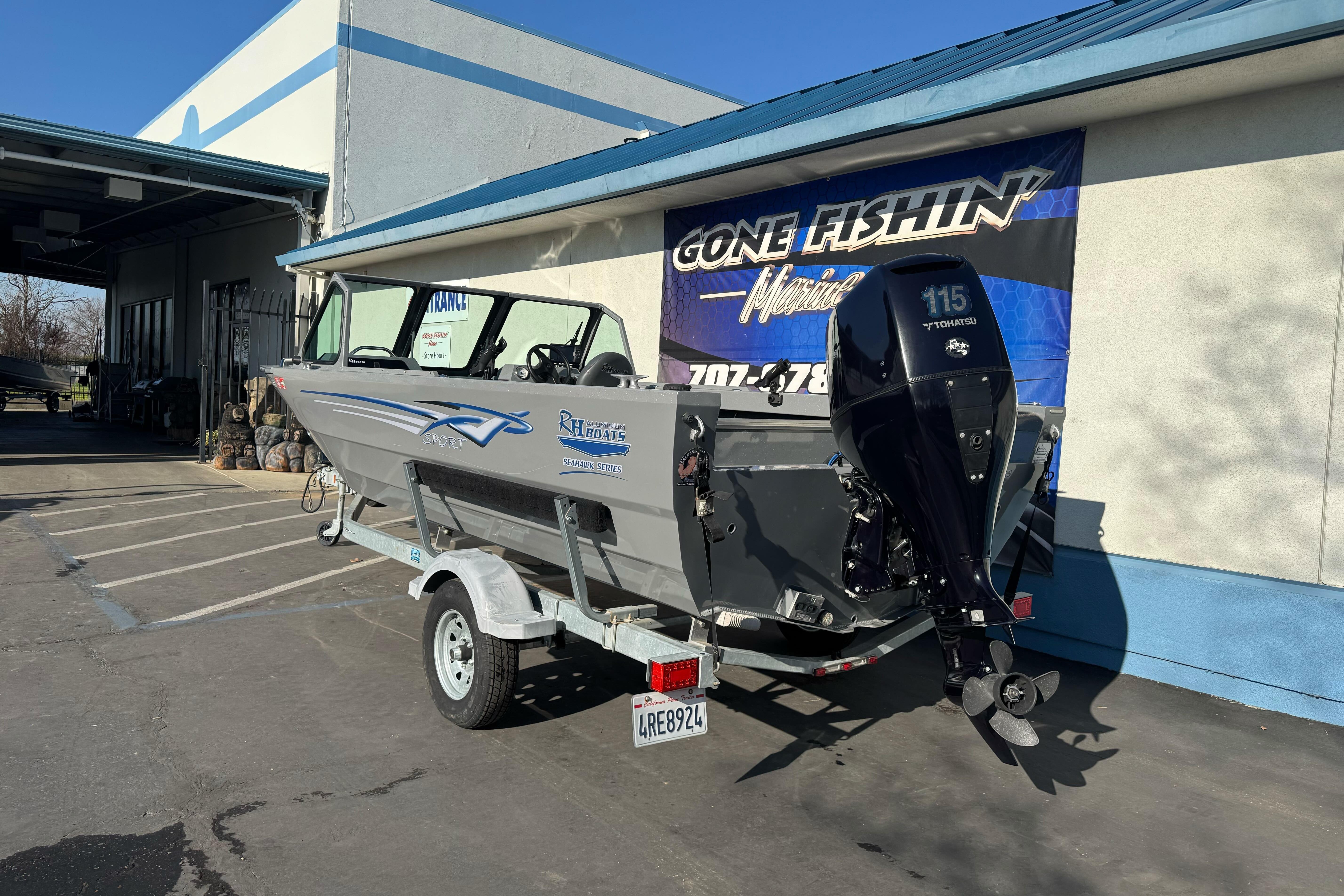 2017 RH Boats 18 SH with Tohatsu 115 engine on trailer outside dealership.