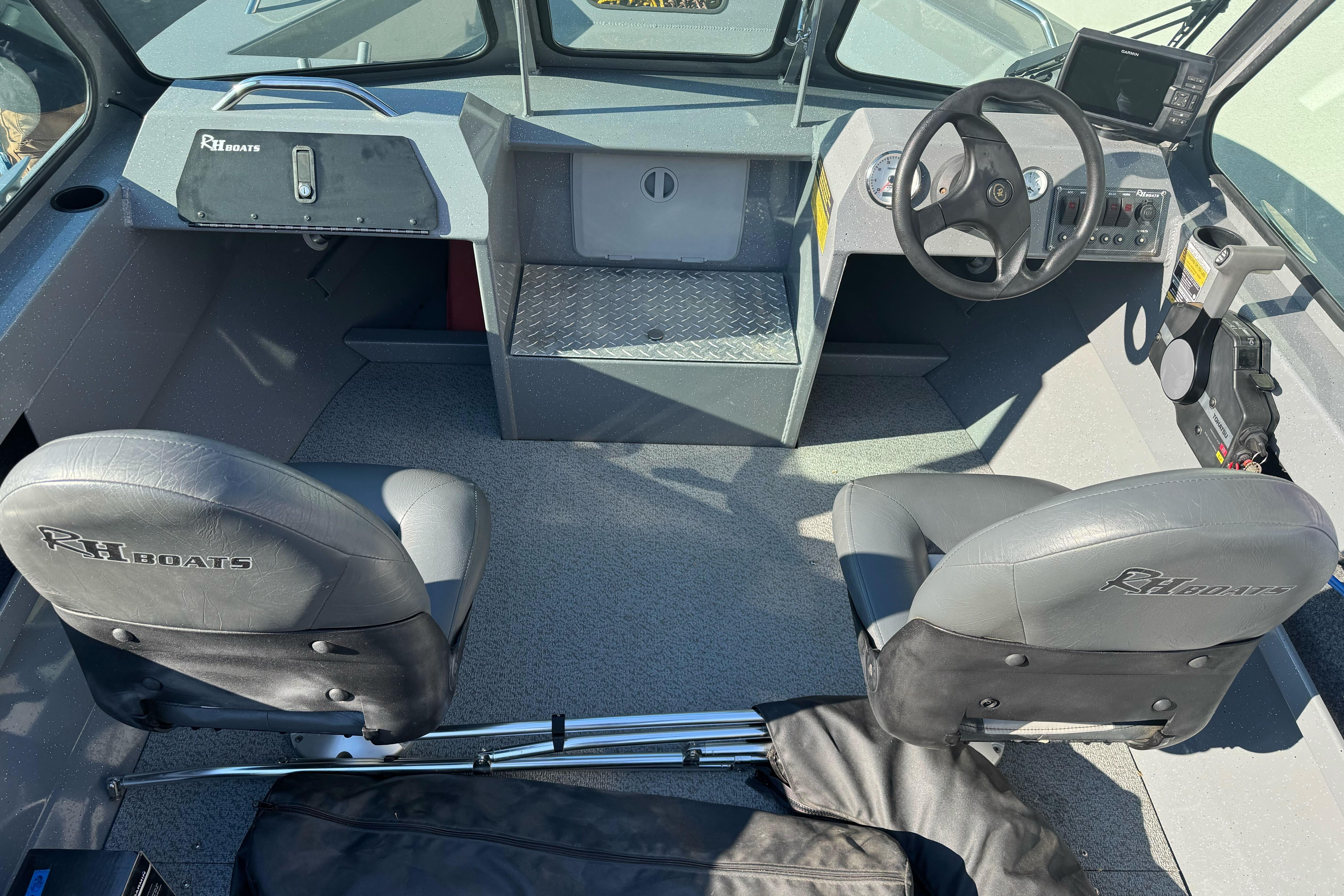 Interior of a 2017 RH Boats 18 SH, featuring dual seats and steering console.