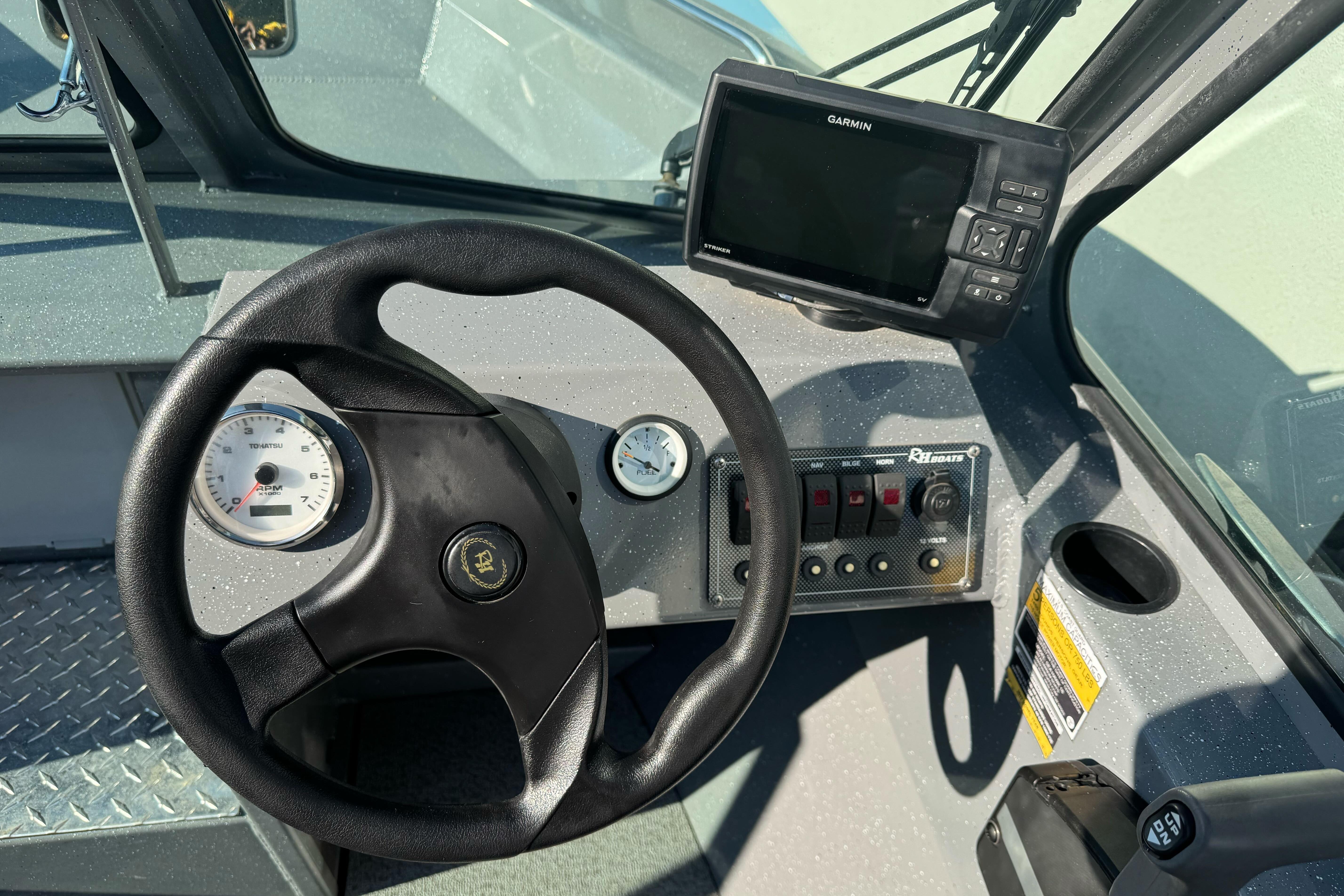 Steering console of 2017 RH Boats 18 SH with Garmin GPS and gauges.