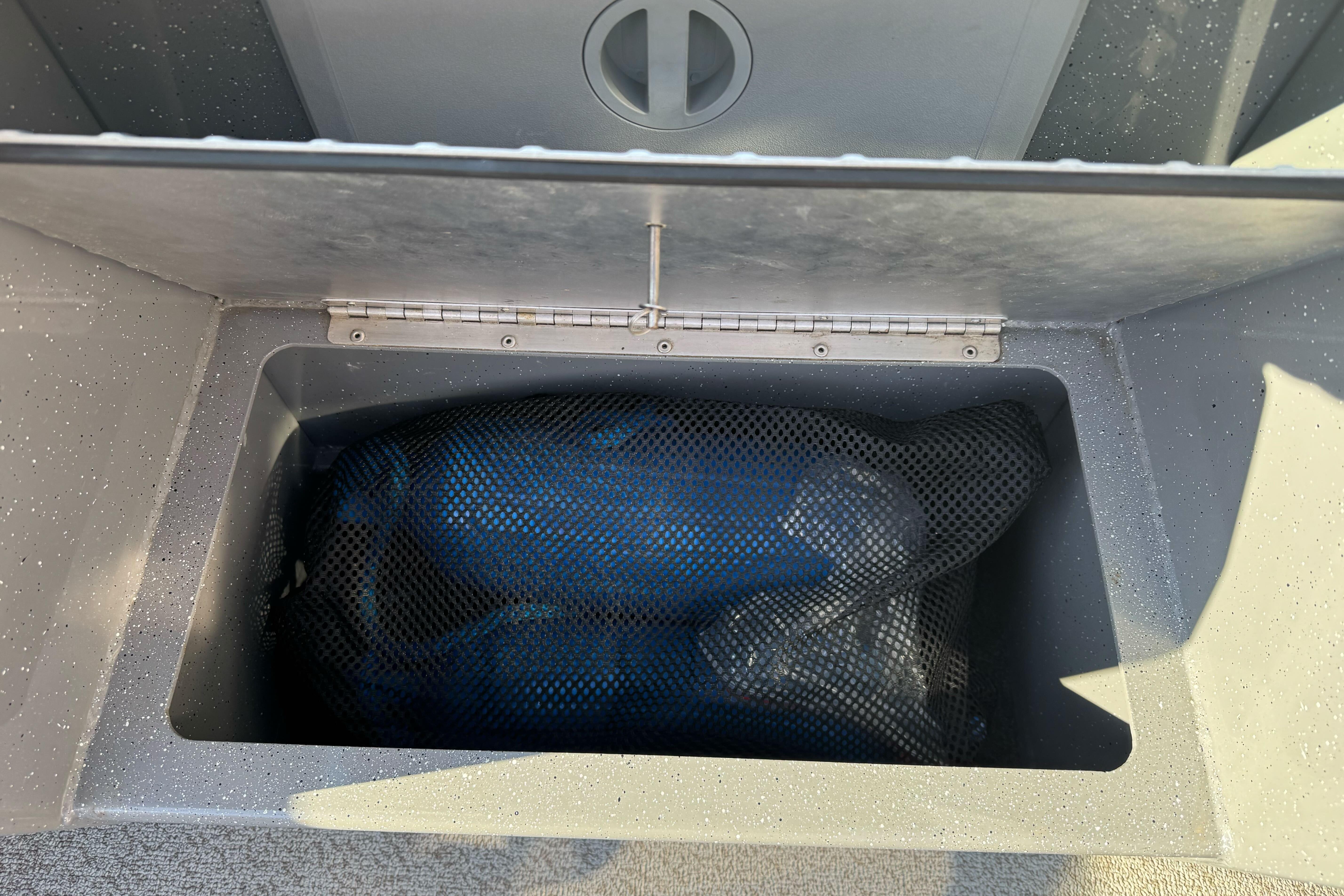 Storage compartment in 2017 RH Boats 18 SH, featuring a mesh bag inside.