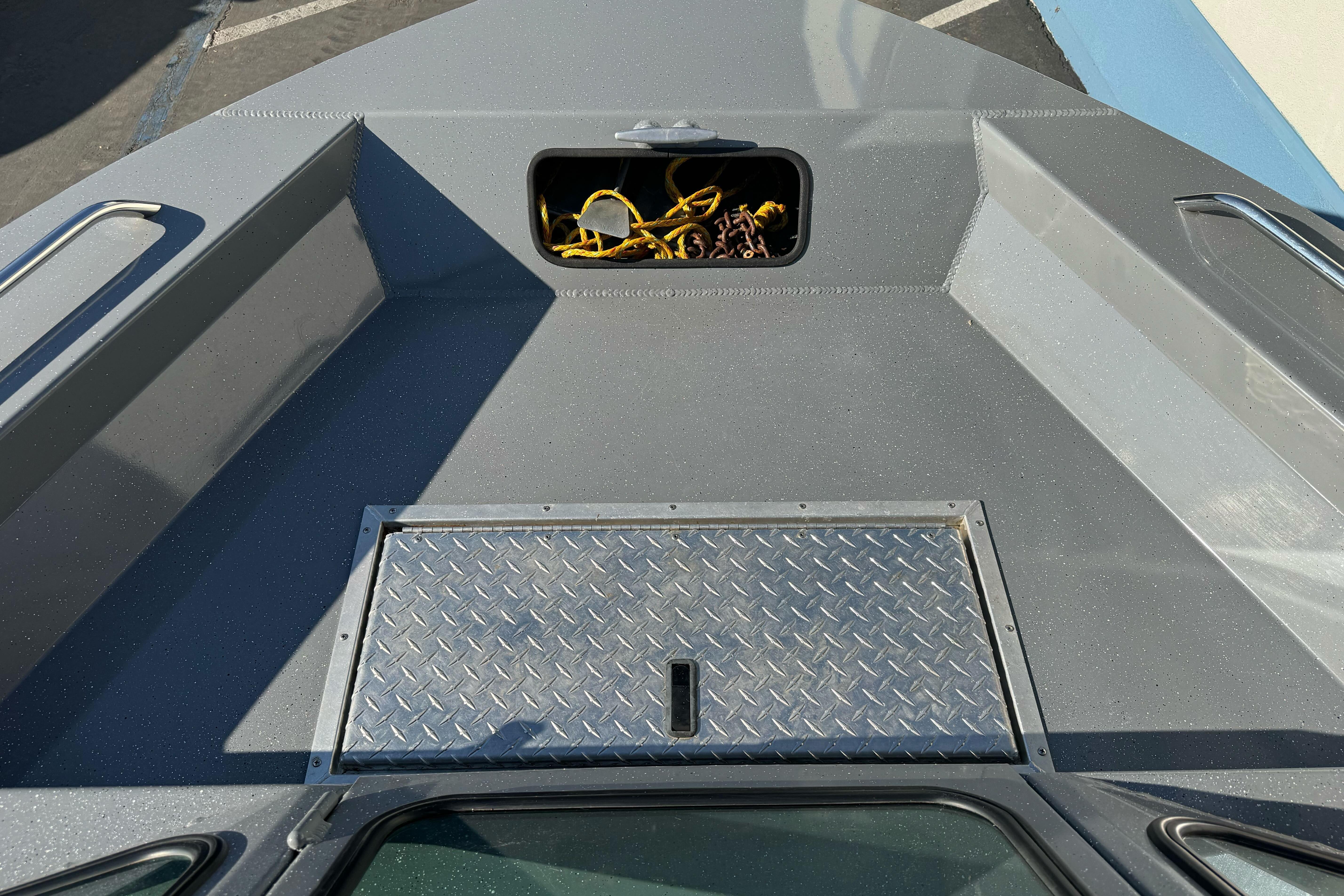 2017 RH Boats 18 SH deck with storage compartment and diamond plate cover.