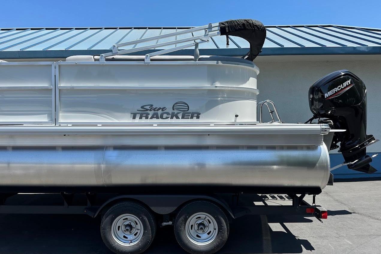 2026 Sun Tracker Party Barge 20 DLX pontoon boat with Mercury outboard motor.