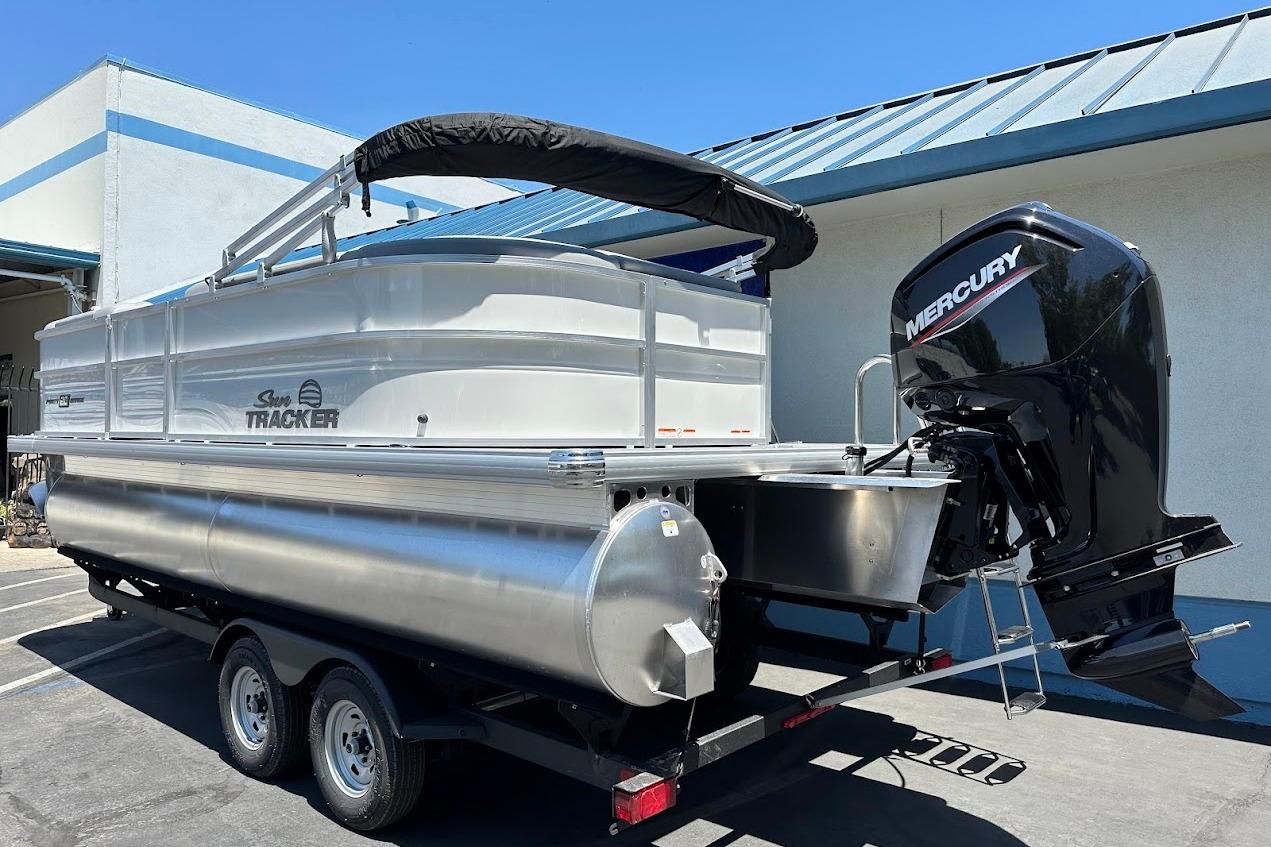 2026 Sun Tracker Party Barge 20 DLX pontoon boat with Mercury outboard motor.