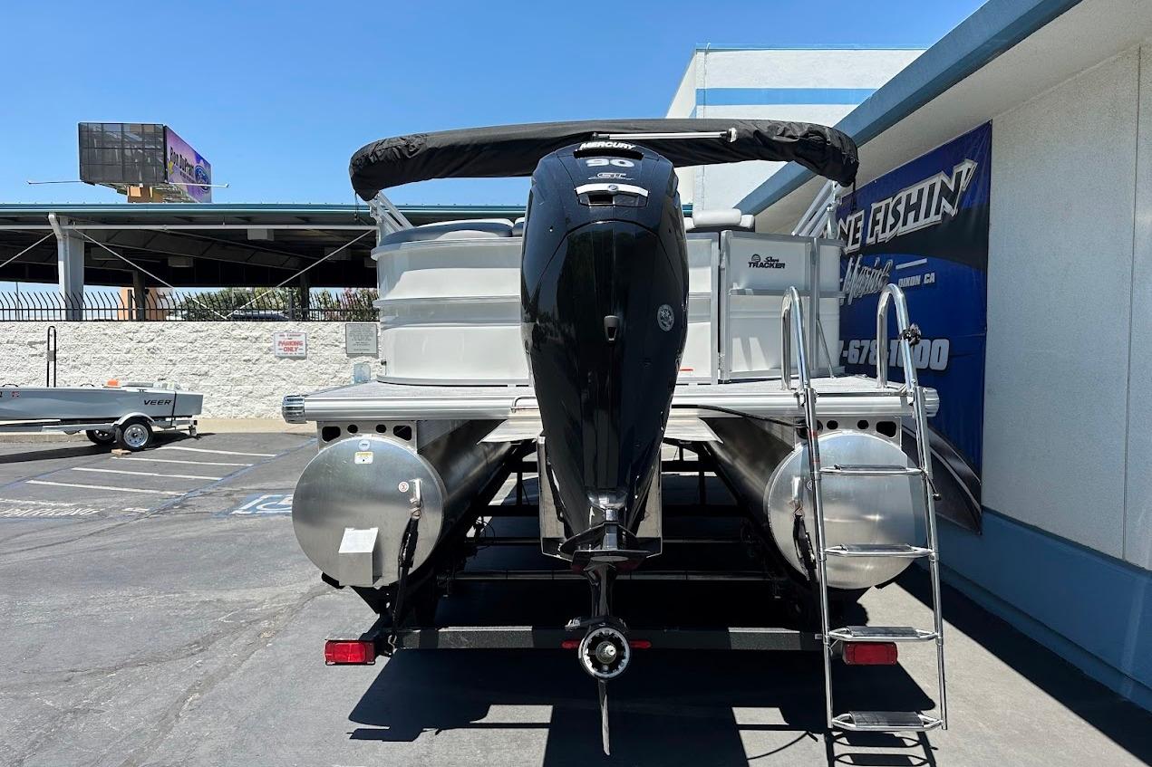 2026 Sun Tracker Party Barge 20 DLX pontoon boat with outboard motor and ladder.
