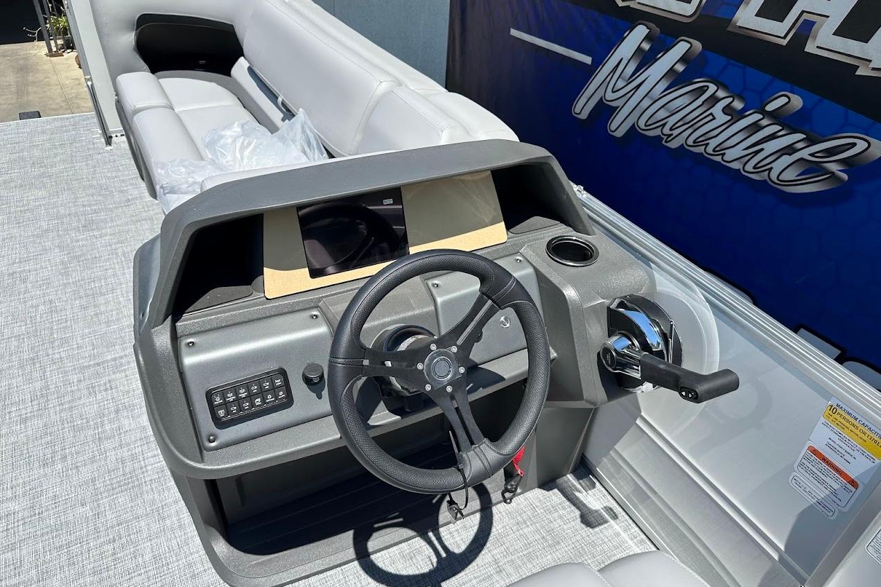 2026 Sun Tracker Party Barge 20 DLX steering console with modern controls and seating.