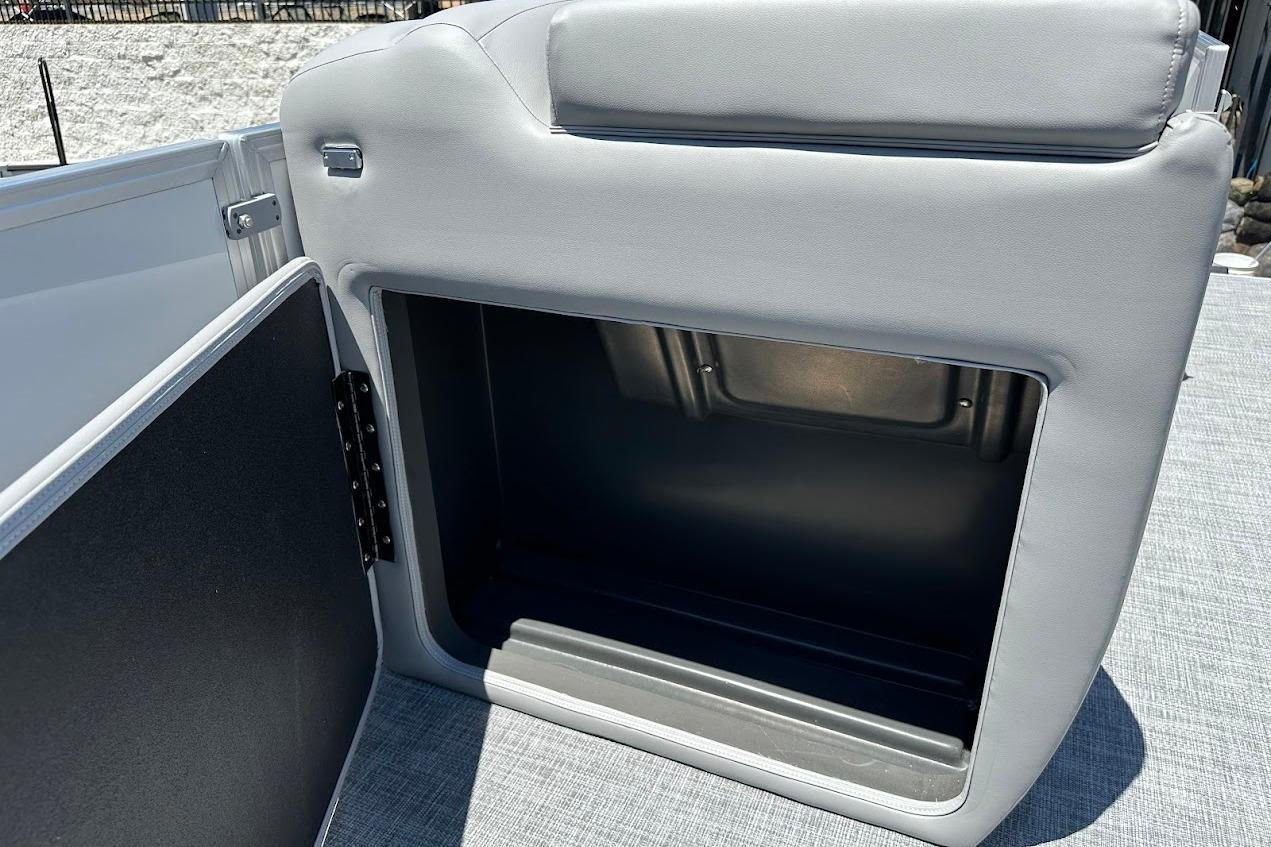 2026 Sun Tracker Party Barge 20 DLX storage compartment with open door, gray upholstery.
