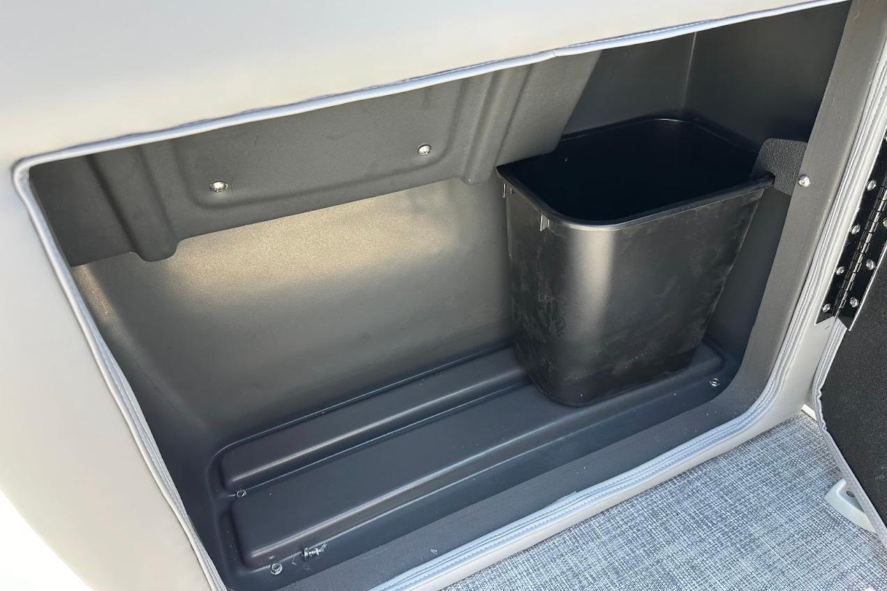Storage compartment with trash bin in 2026 Sun Tracker Party Barge 20 DLX.