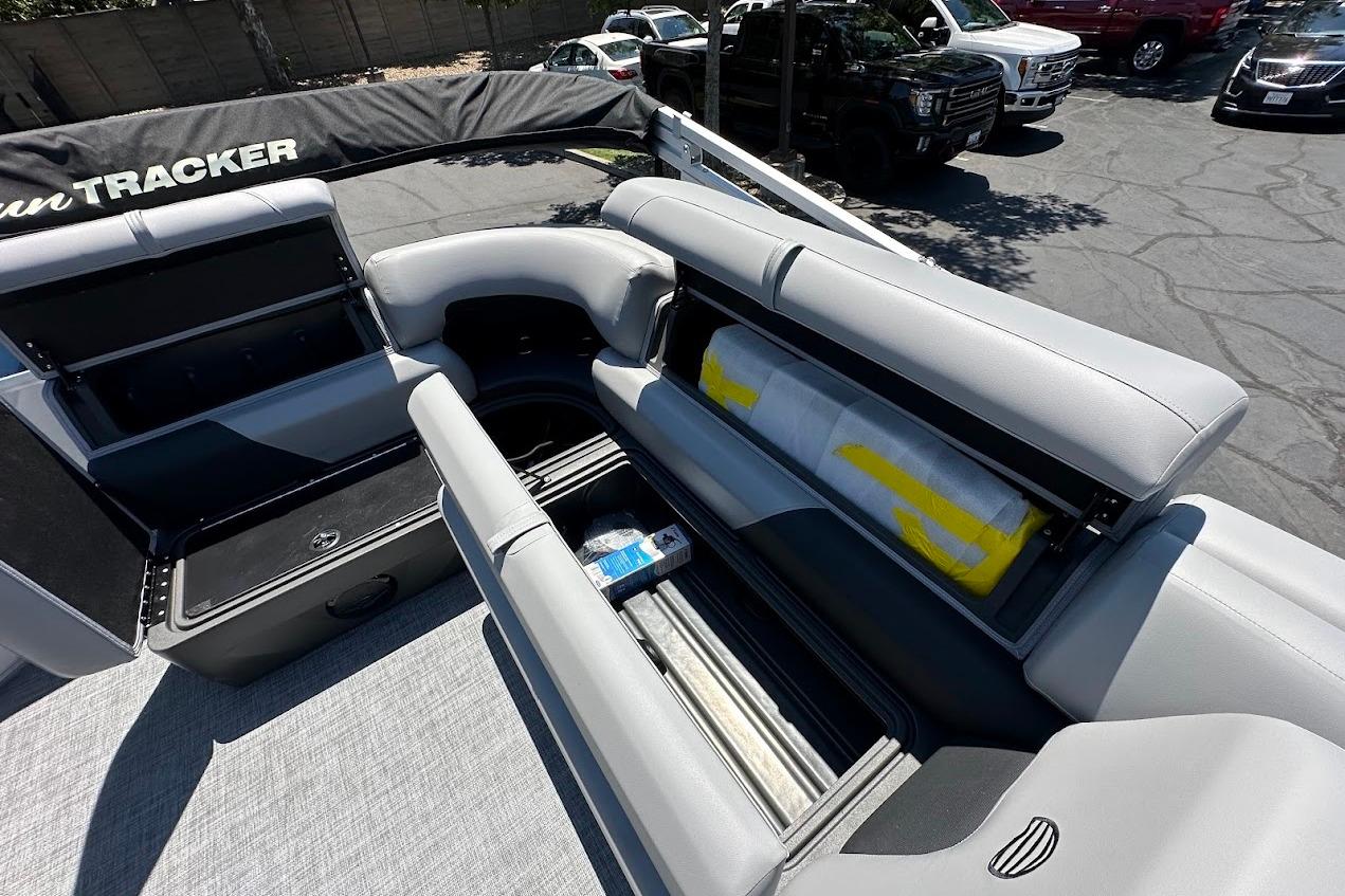 2026 Sun Tracker Party Barge 20 DLX interior with open storage compartments.
