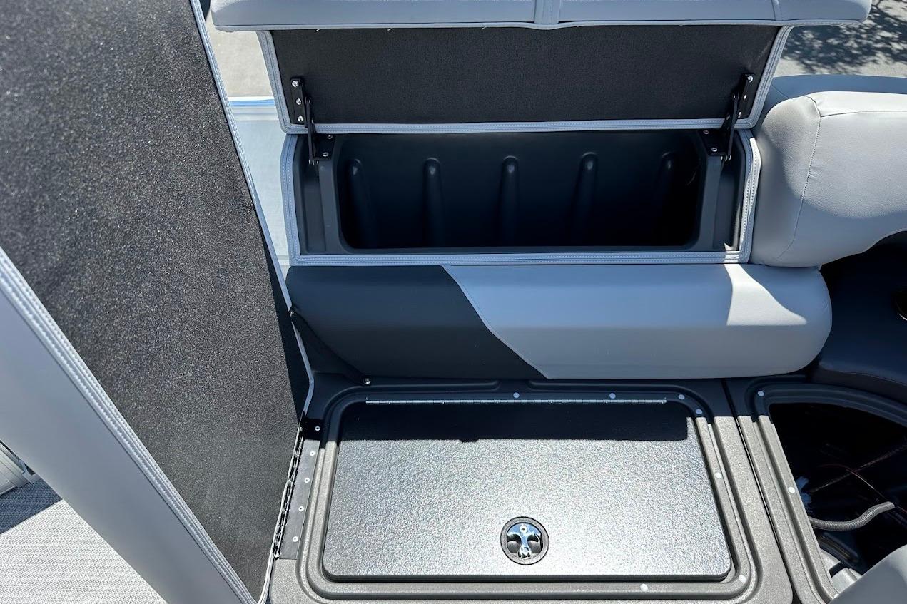 2026 Sun Tracker Party Barge 20 DLX storage compartment with open lid, showcasing interior space.