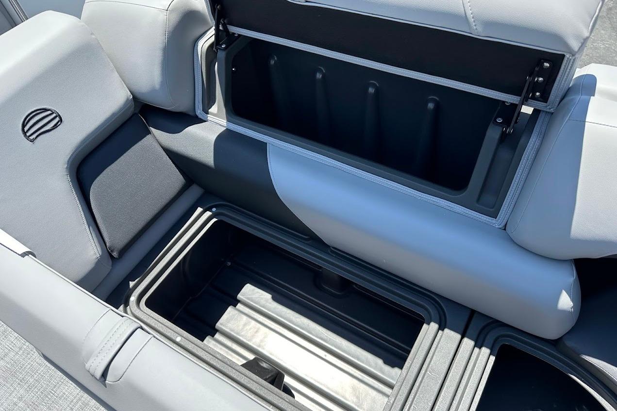 2026 Sun Tracker Party Barge 20 DLX storage compartment with open lid, showcasing spacious interior.