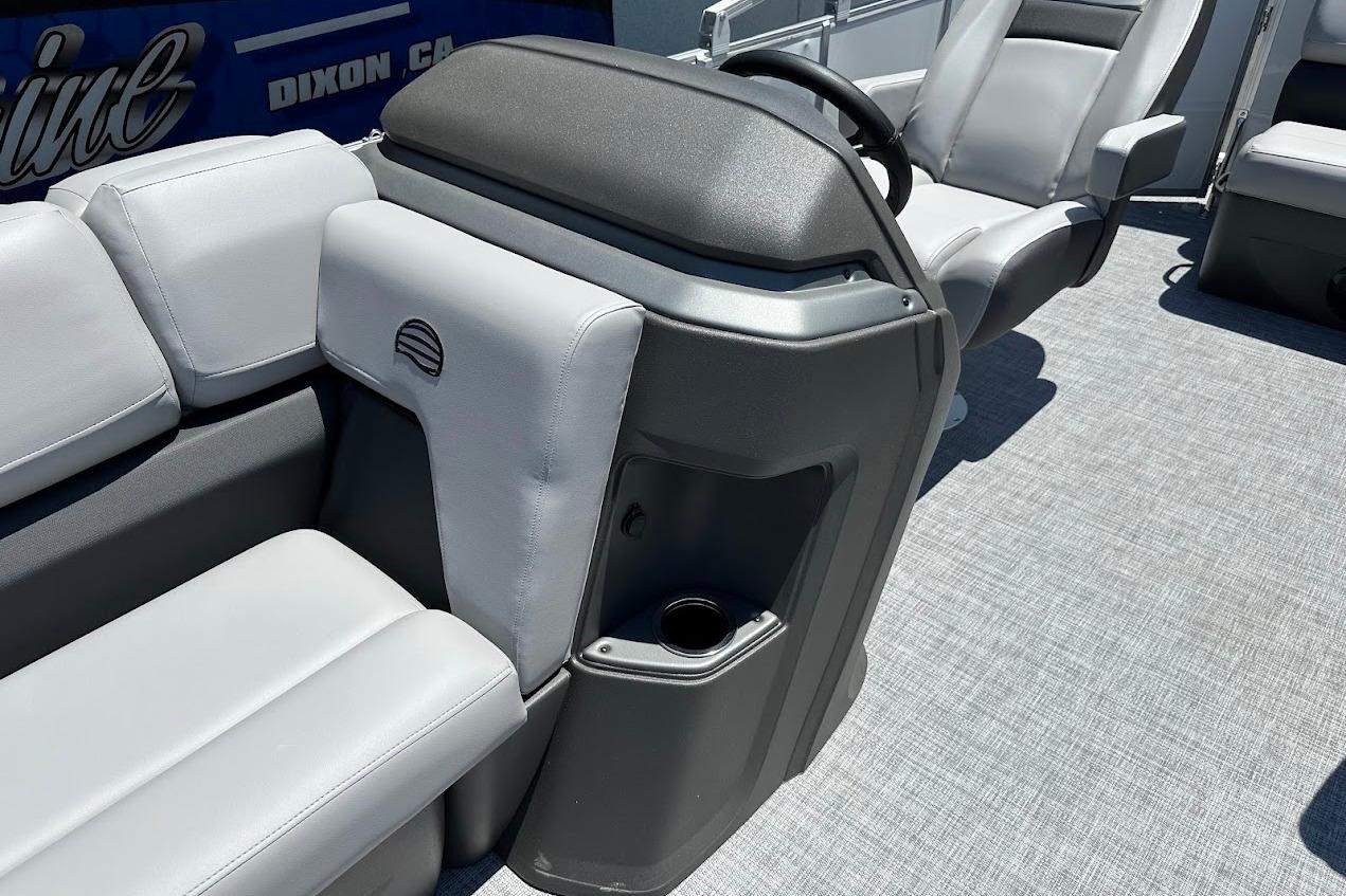 2026 Sun Tracker Party Barge 20 DLX interior with gray seating and steering console.