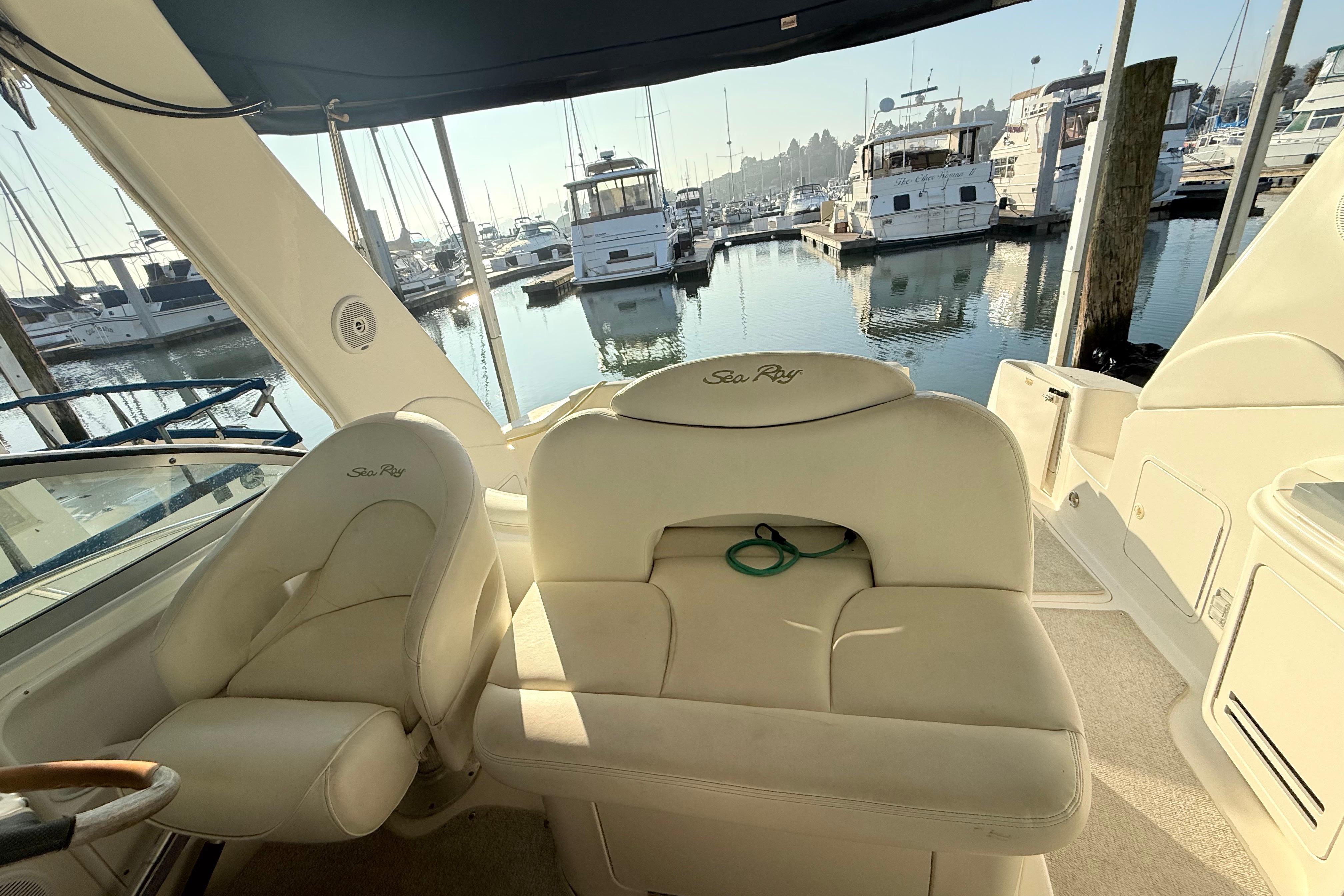 Interior of 2001 Sea Ray 340 Sundancer yacht with marina view in background.