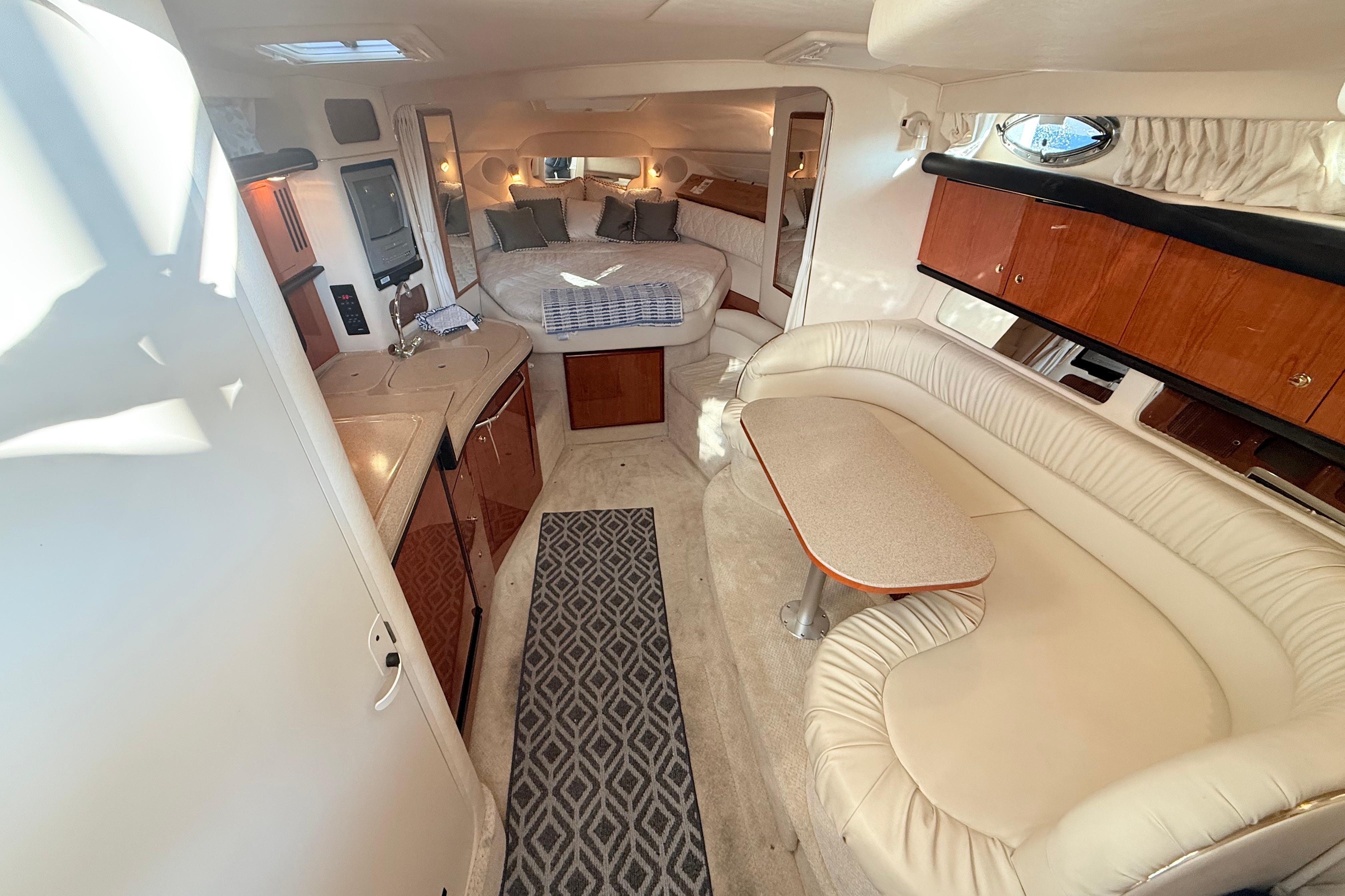 Interior of 2001 Sea Ray 340 Sundancer yacht with cozy seating and elegant design.