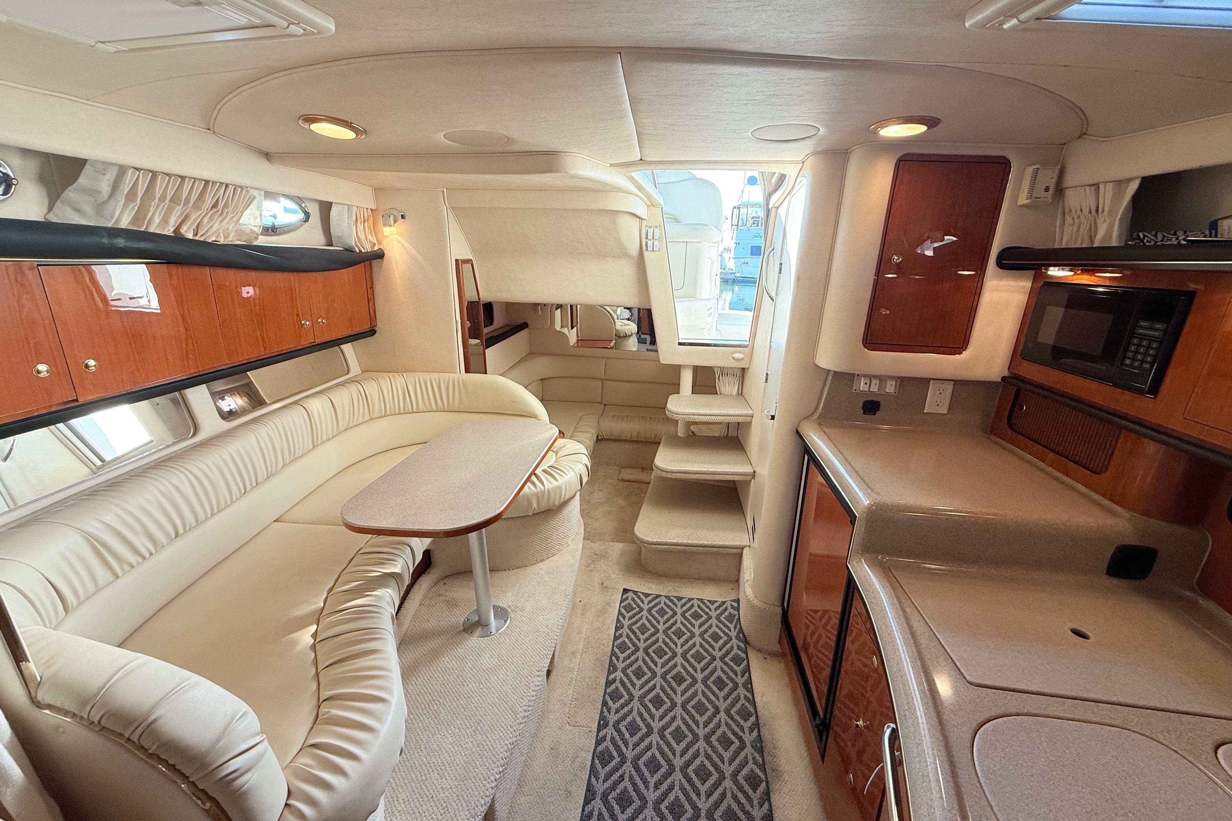 Luxurious interior of 2001 Sea Ray 340 Sundancer yacht with plush seating and modern amenities.