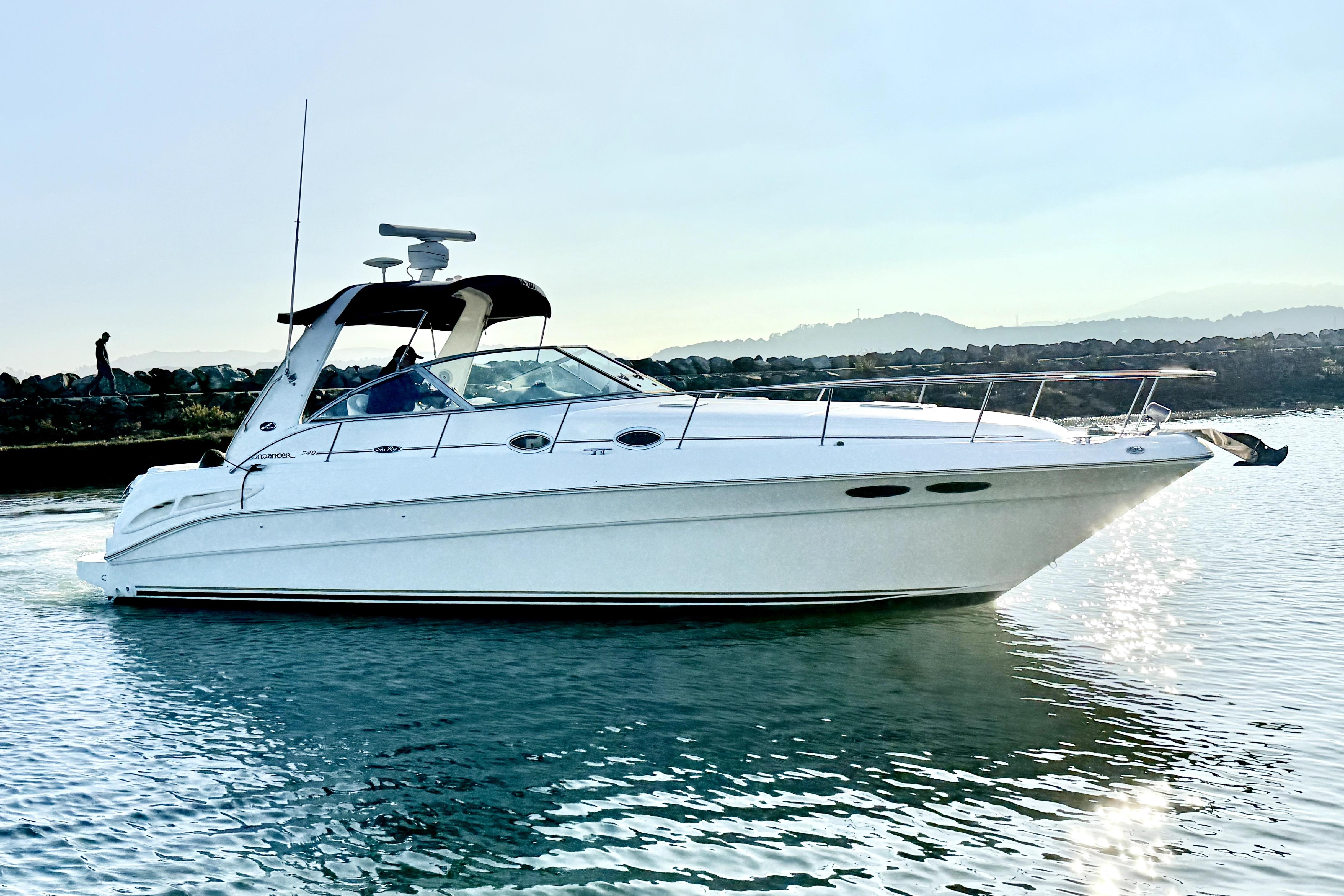 2001 Sea Ray 340 Sundancer yacht cruising on calm water.