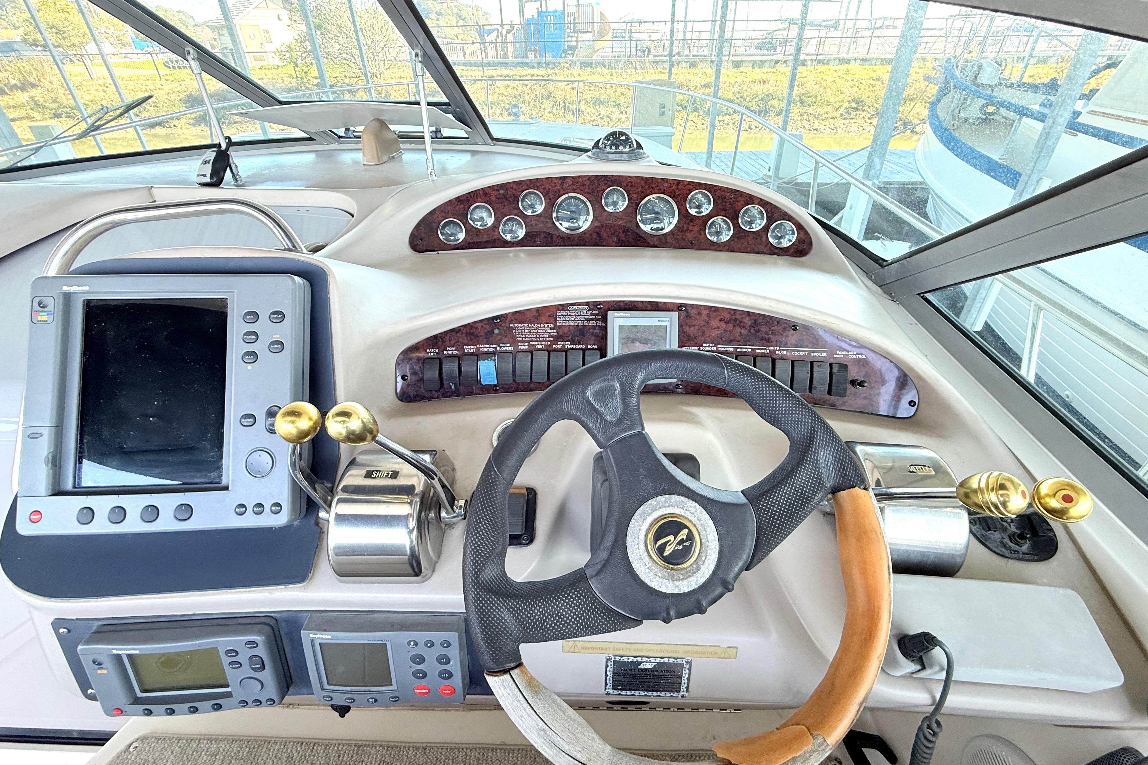 Helm of 2001 Sea Ray 340 Sundancer with steering wheel and navigation controls.